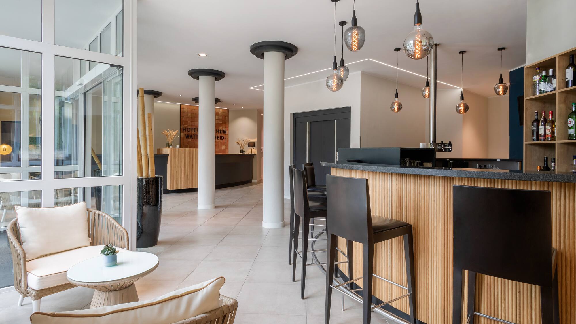 a bar with chairs and a table in a room