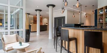 a bar with chairs and a table in a room