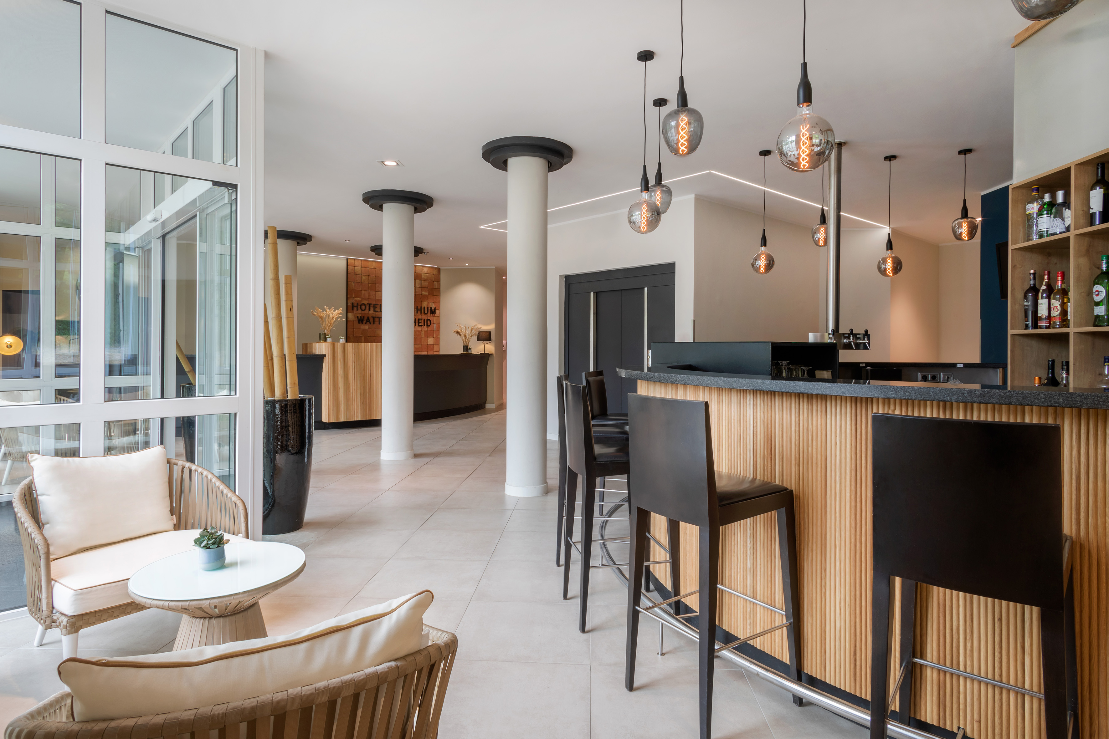 Modern hotel lobby with bar, reception, and lounge seating. Contemporary design.