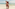 Familia sonriente en playa tropical: padres con niña feliz junto al mar.