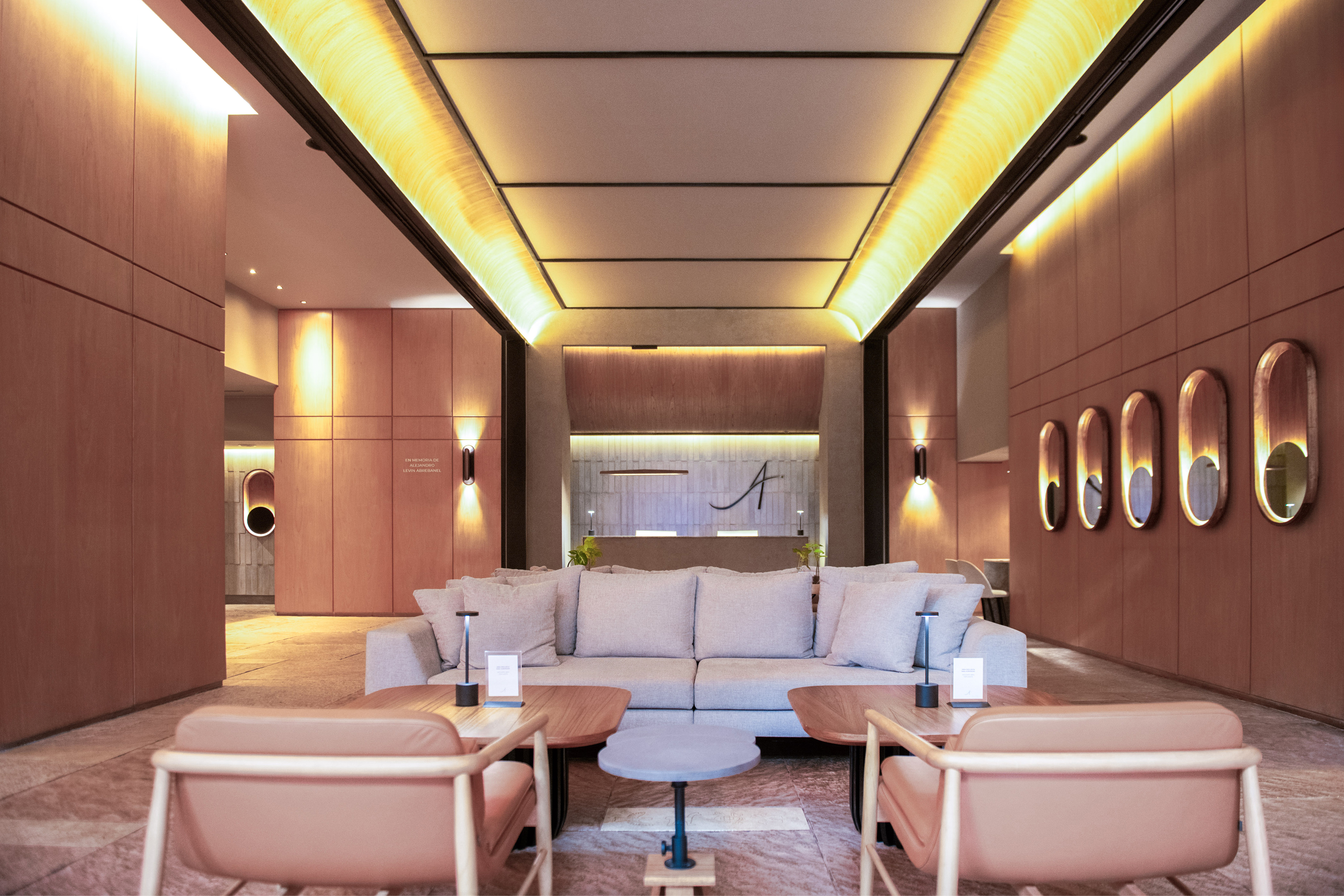 Modern hotel lobby with wood panels, comfortable seating, and reception area.