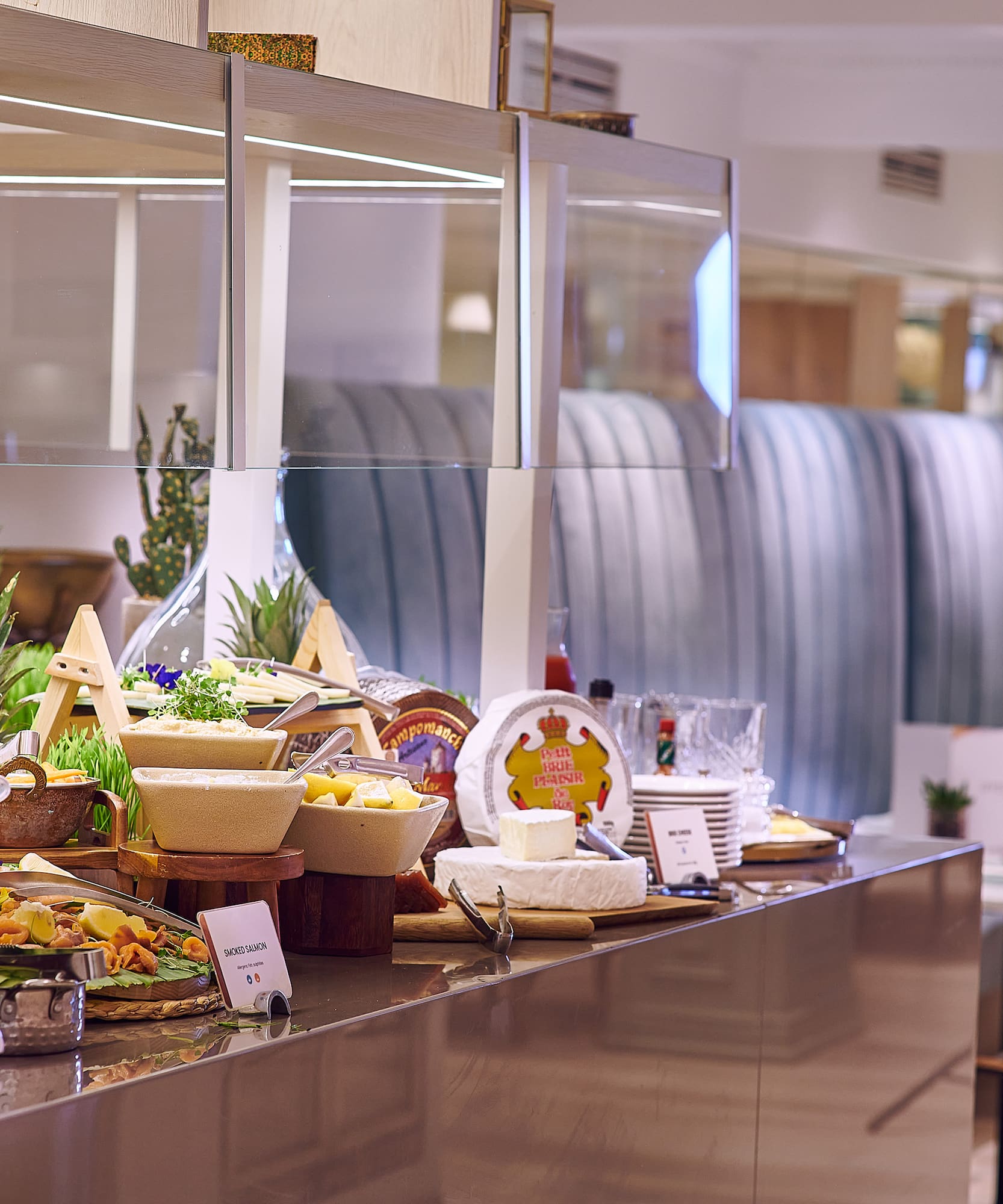 Hotel buffet with cheese, smoked salmon, guacamole, and fresh fruits.