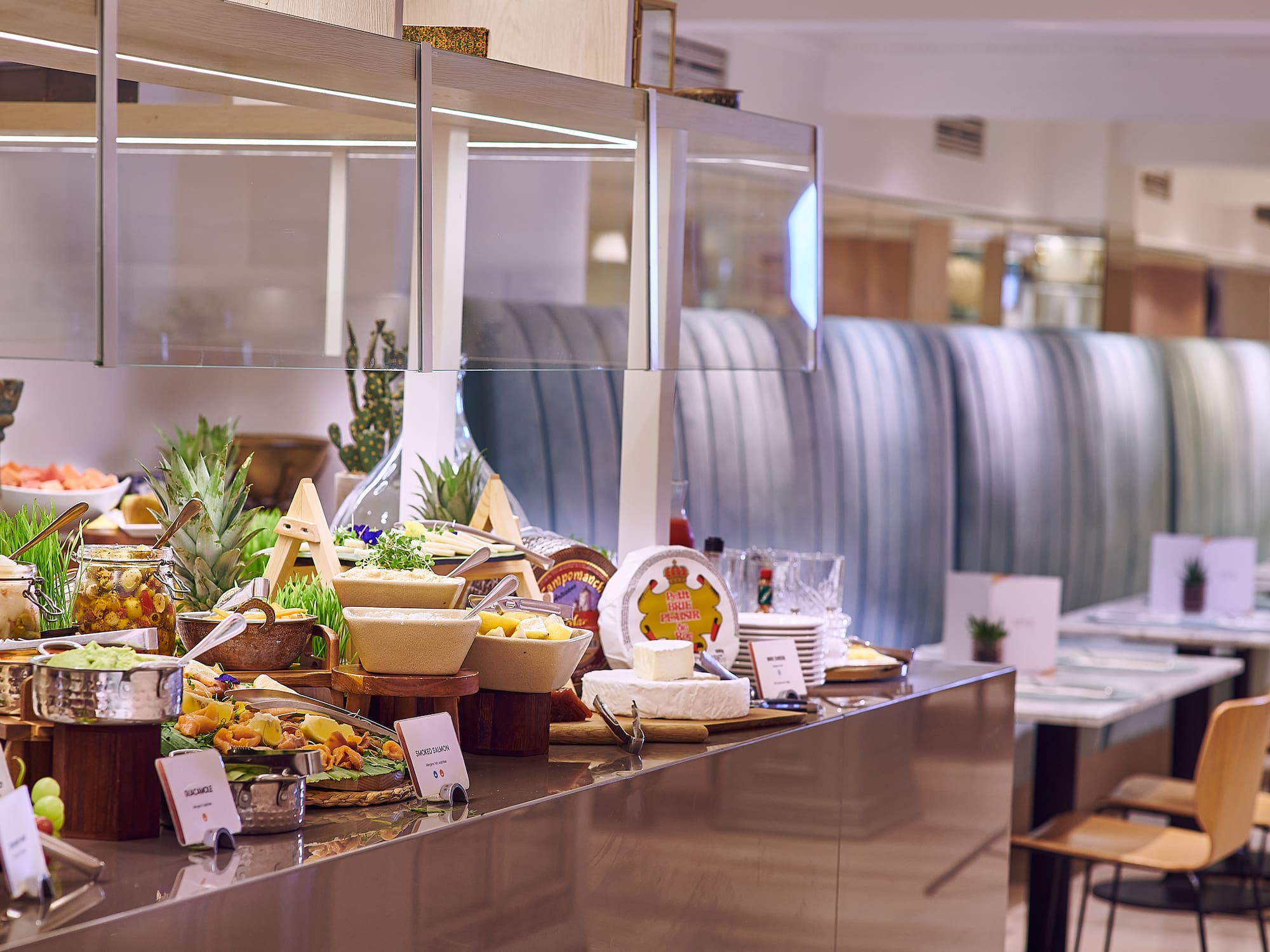 Hotel breakfast buffet with cheese, smoked salmon, guacamole, and fresh fruit.