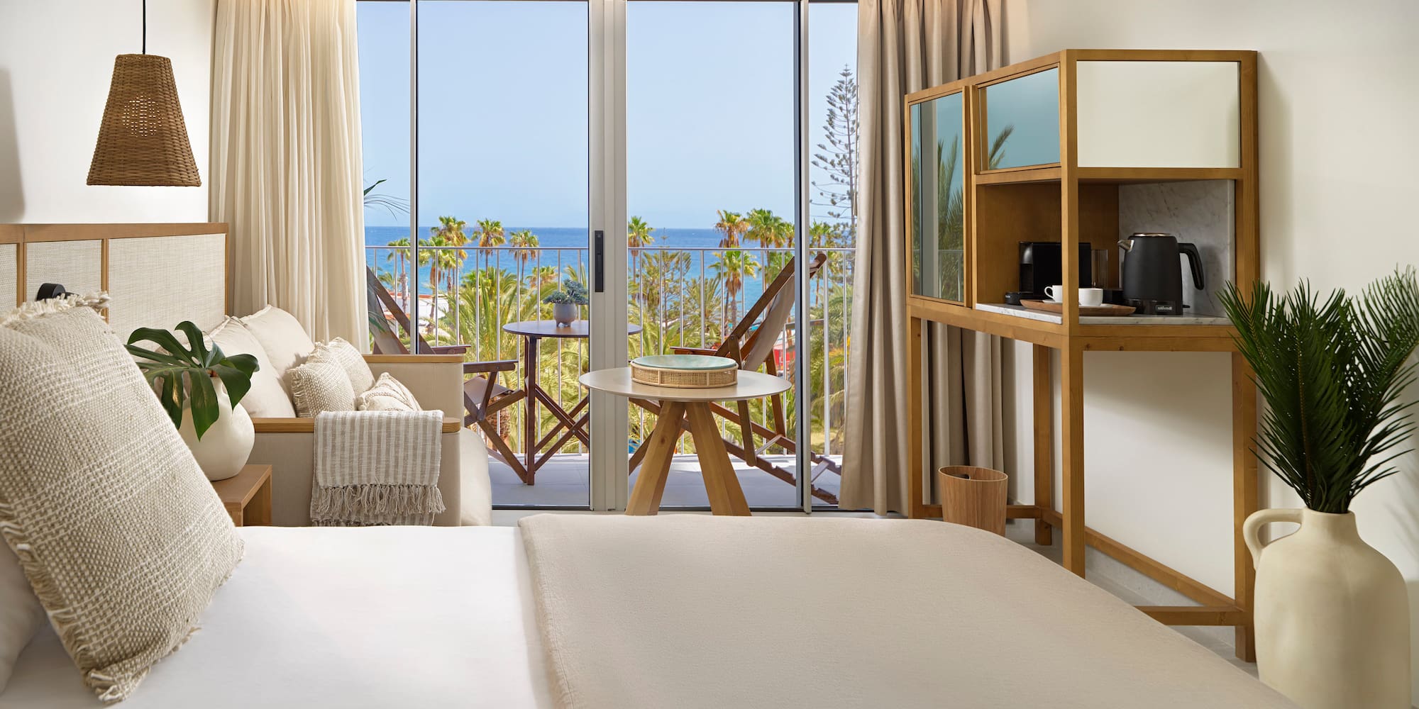 a room with a bed and a table and chairs