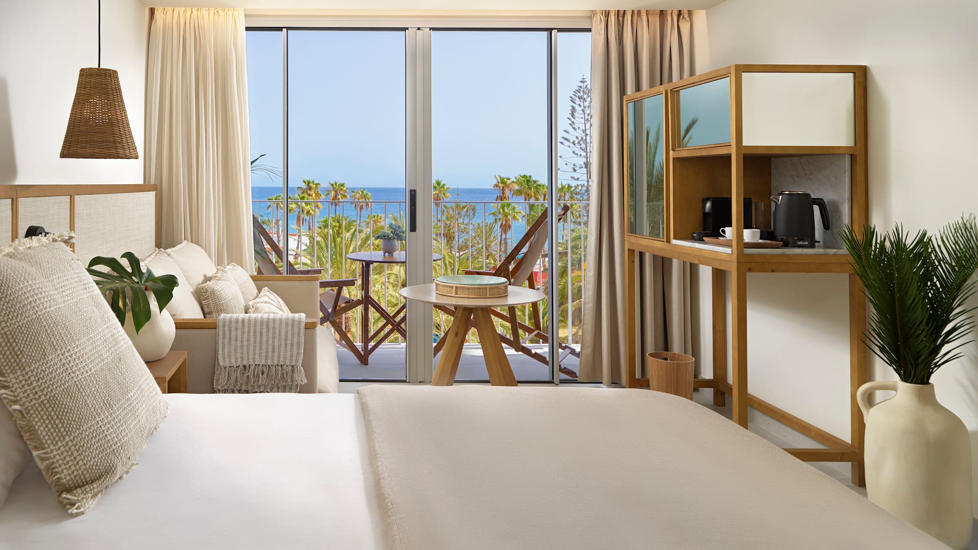 a room with a bed and a table and chairs