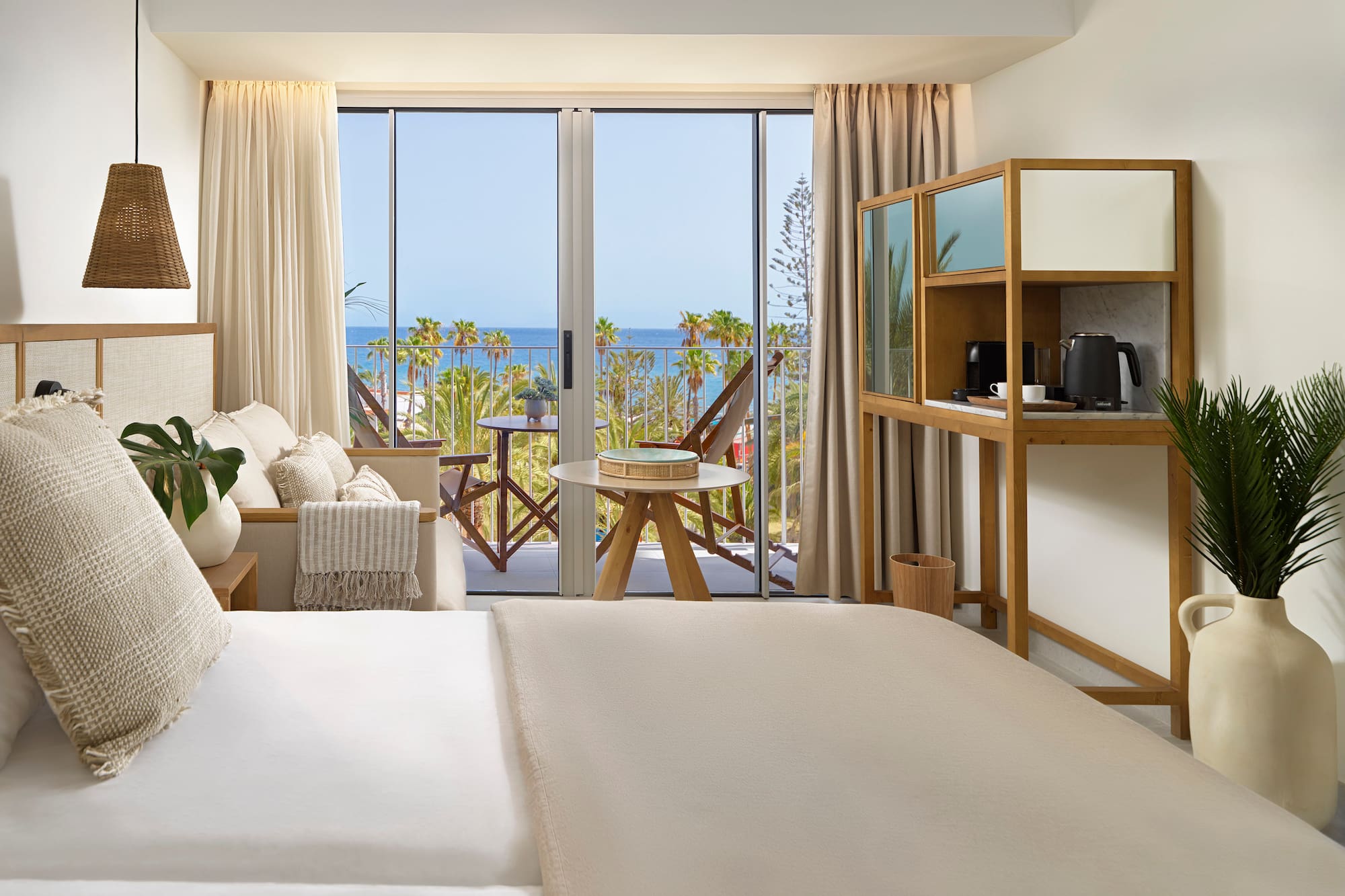 a room with a bed and a table and chairs