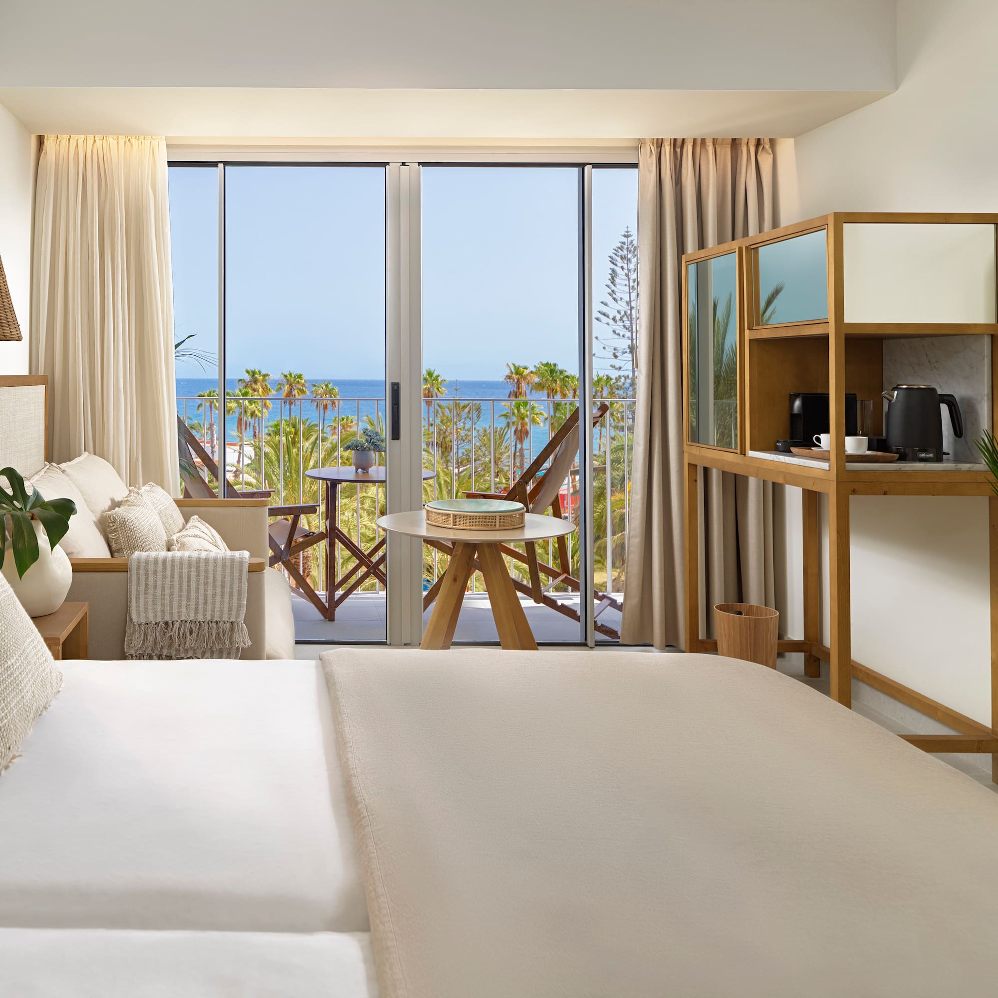 a room with a bed and a table and chairs