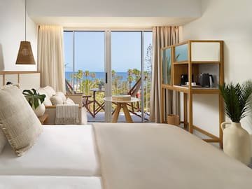 a room with a bed and a table and chairs