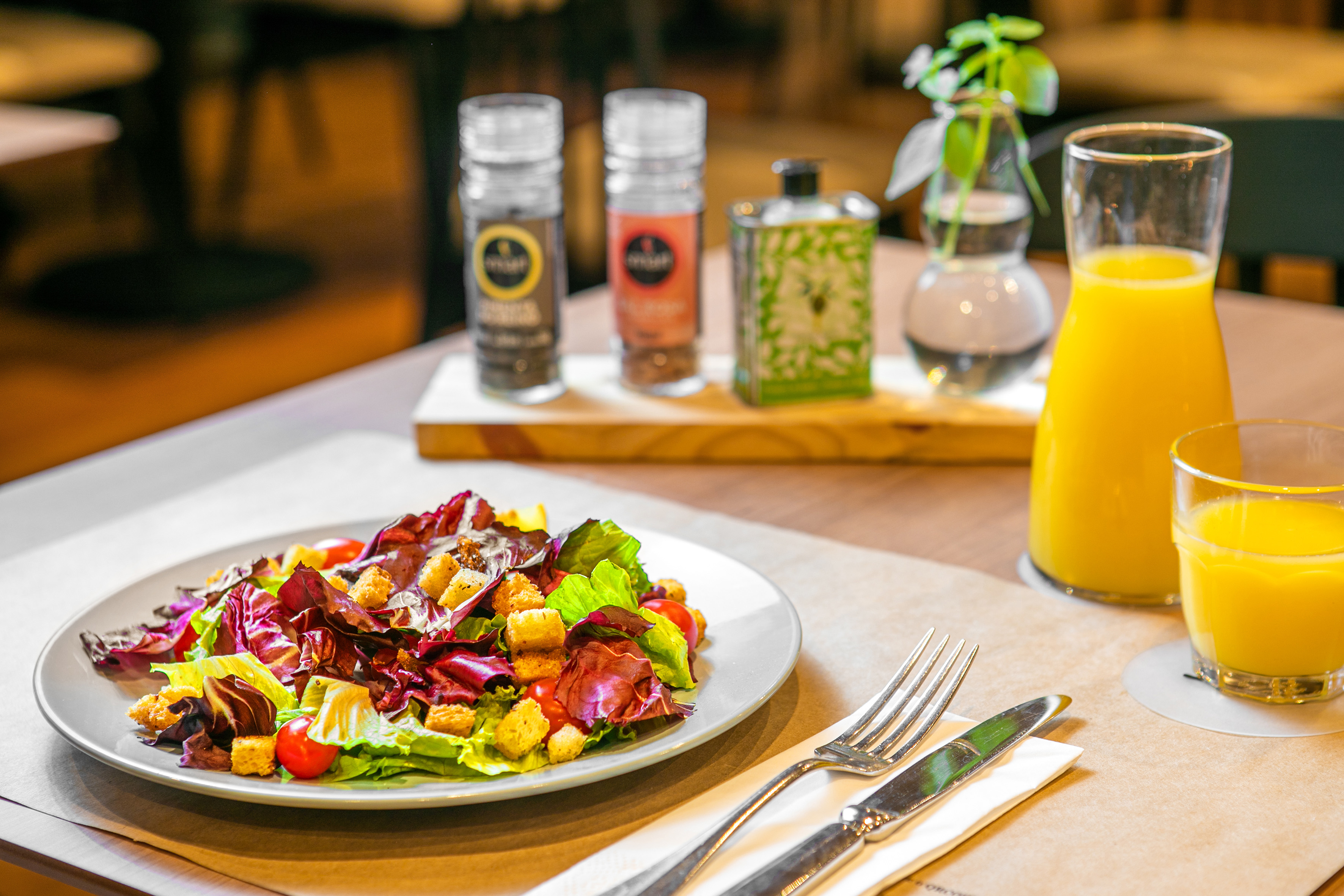 a plate of salad and a glass of juice
