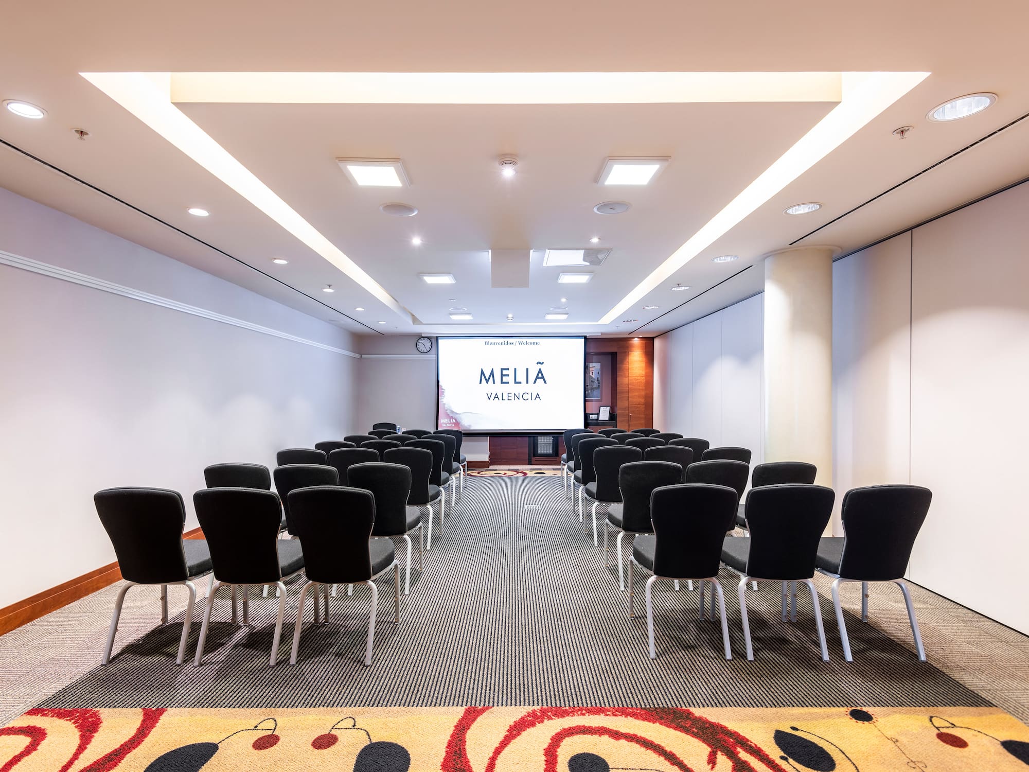 a room with chairs and a projector screen