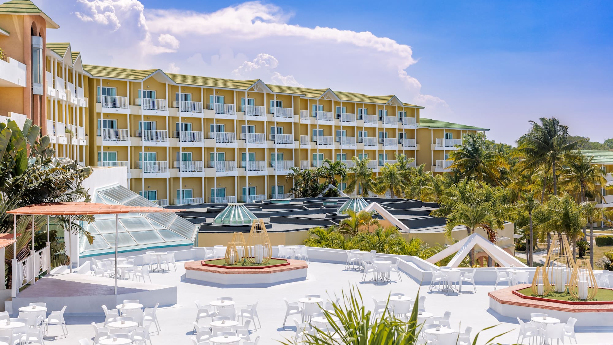 a building with many white tables and chairs