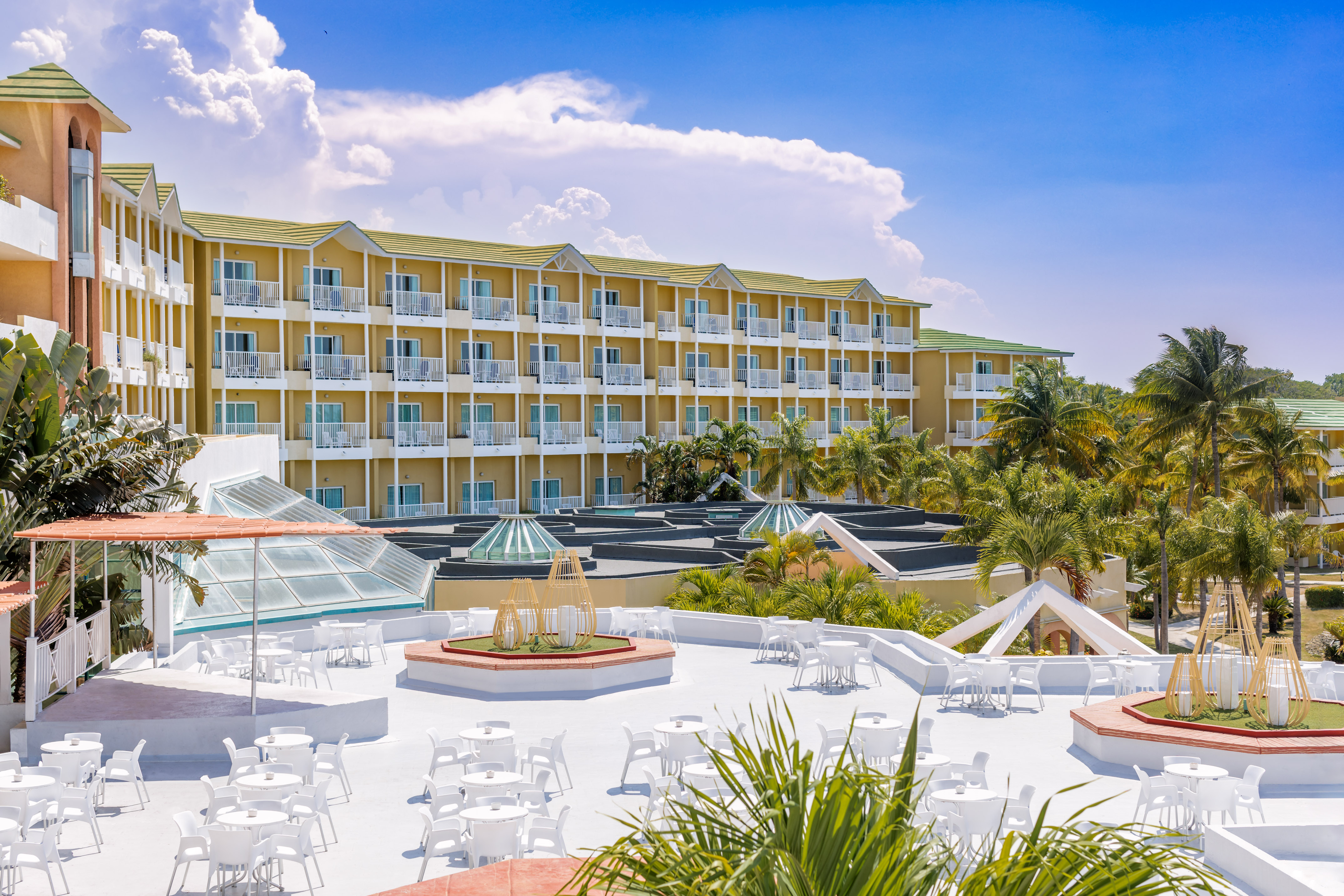 a building with many white tables and chairs