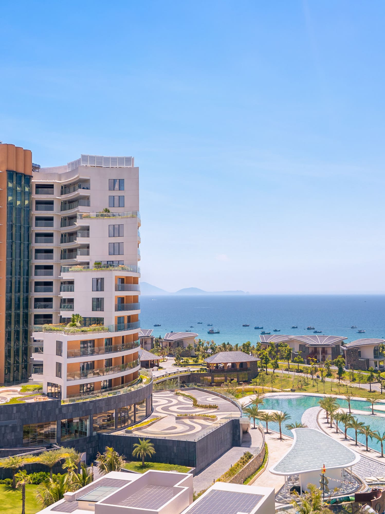 Luxury Melia resort overlooking ocean, pools, and tropical landscaping.