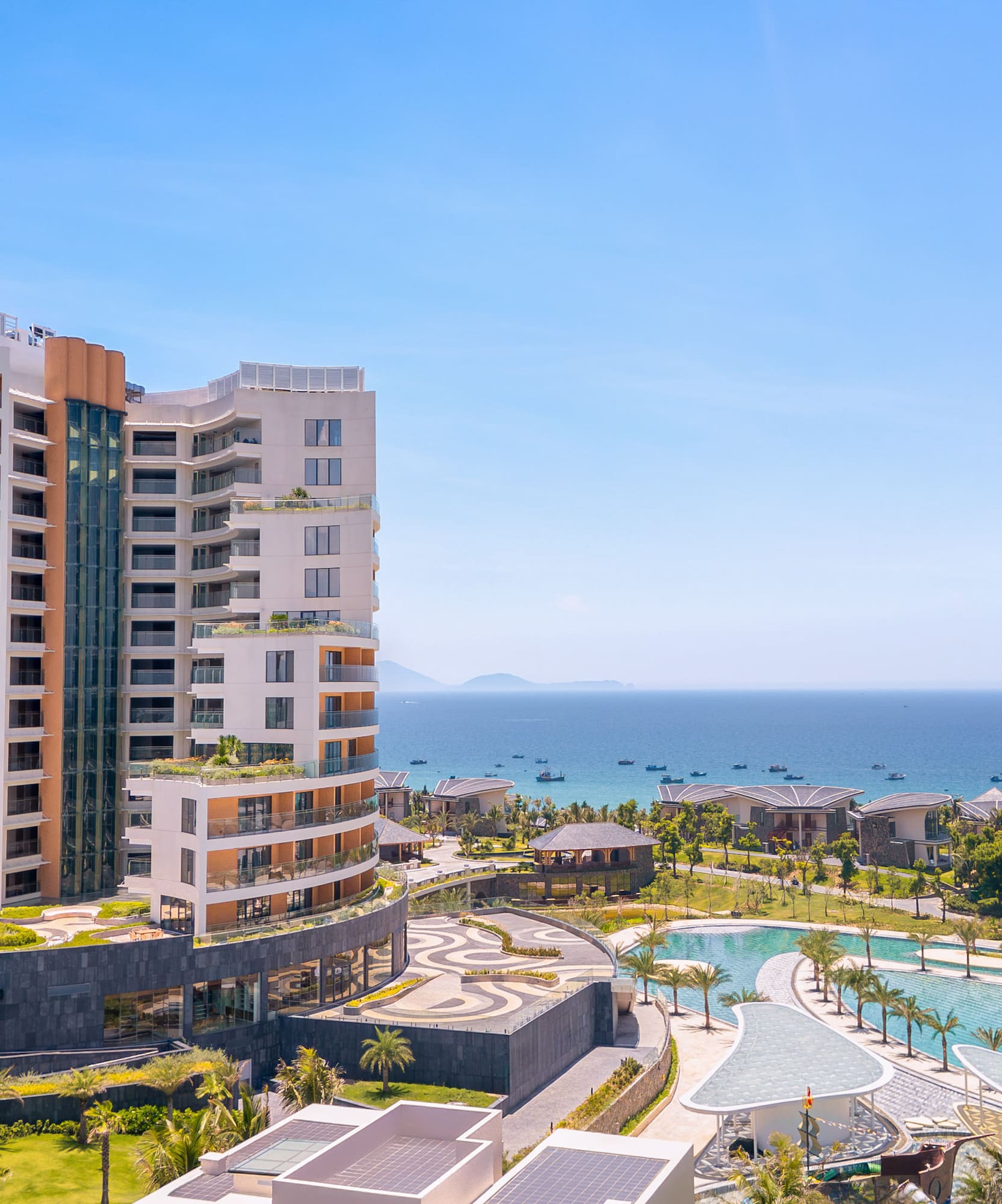 Luxury Melia resort overlooking ocean, pools, and tropical landscaping.