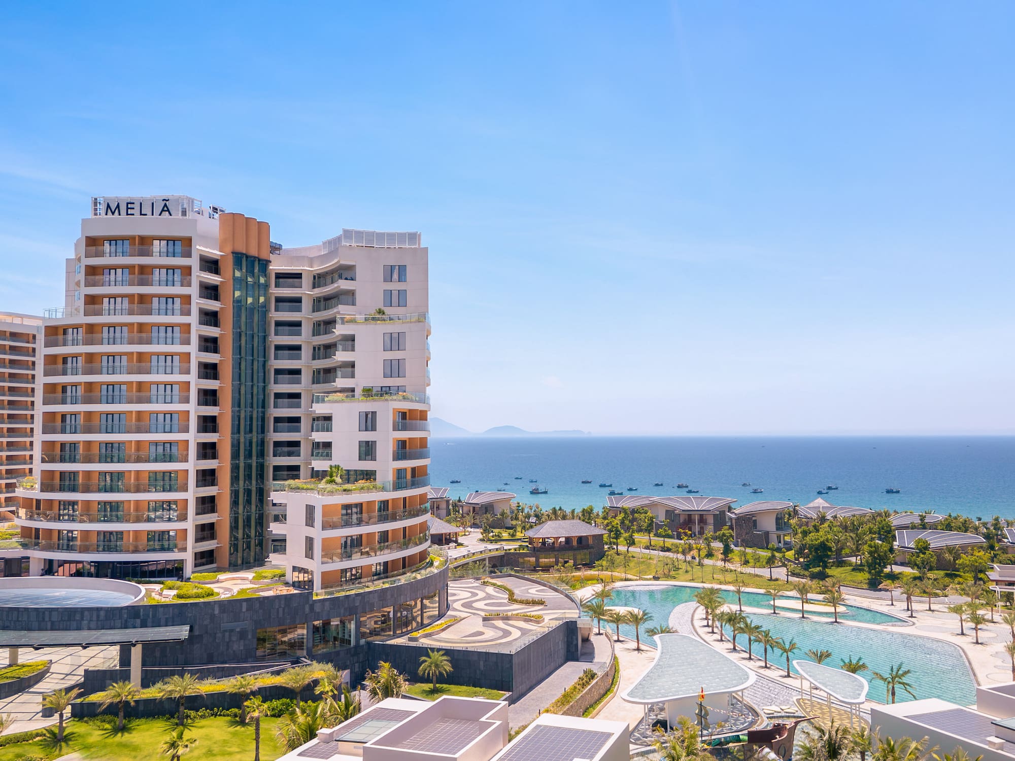 Melia beachfront resort with large pools, palm trees, and ocean view.