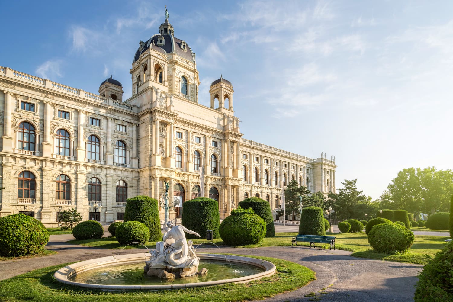 a large white building with a fountain in front of it