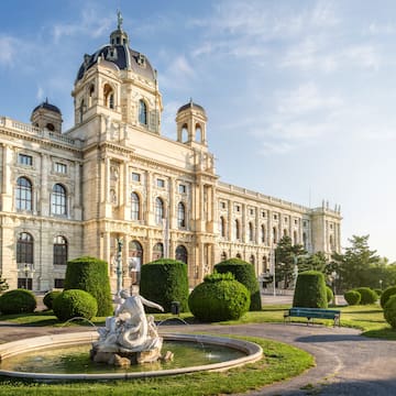 a large white building with a fountain in front of it