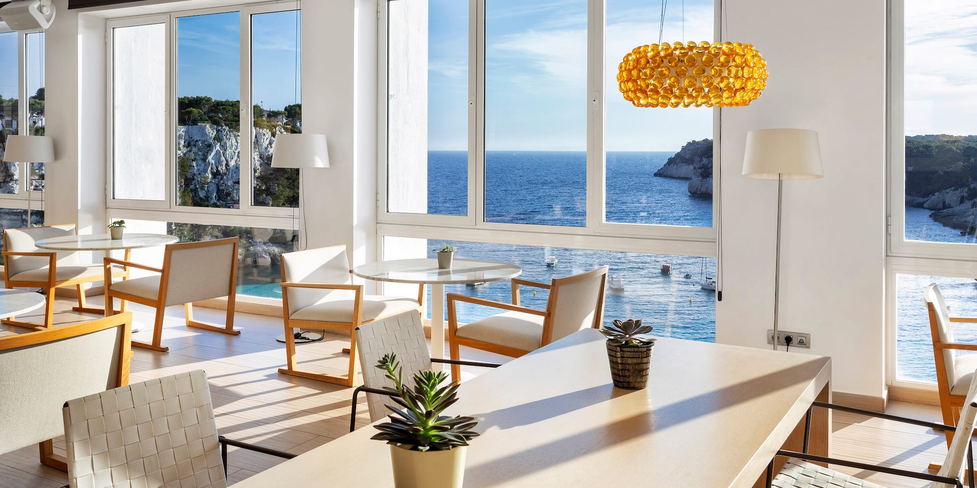 a room with a large window overlooking the ocean