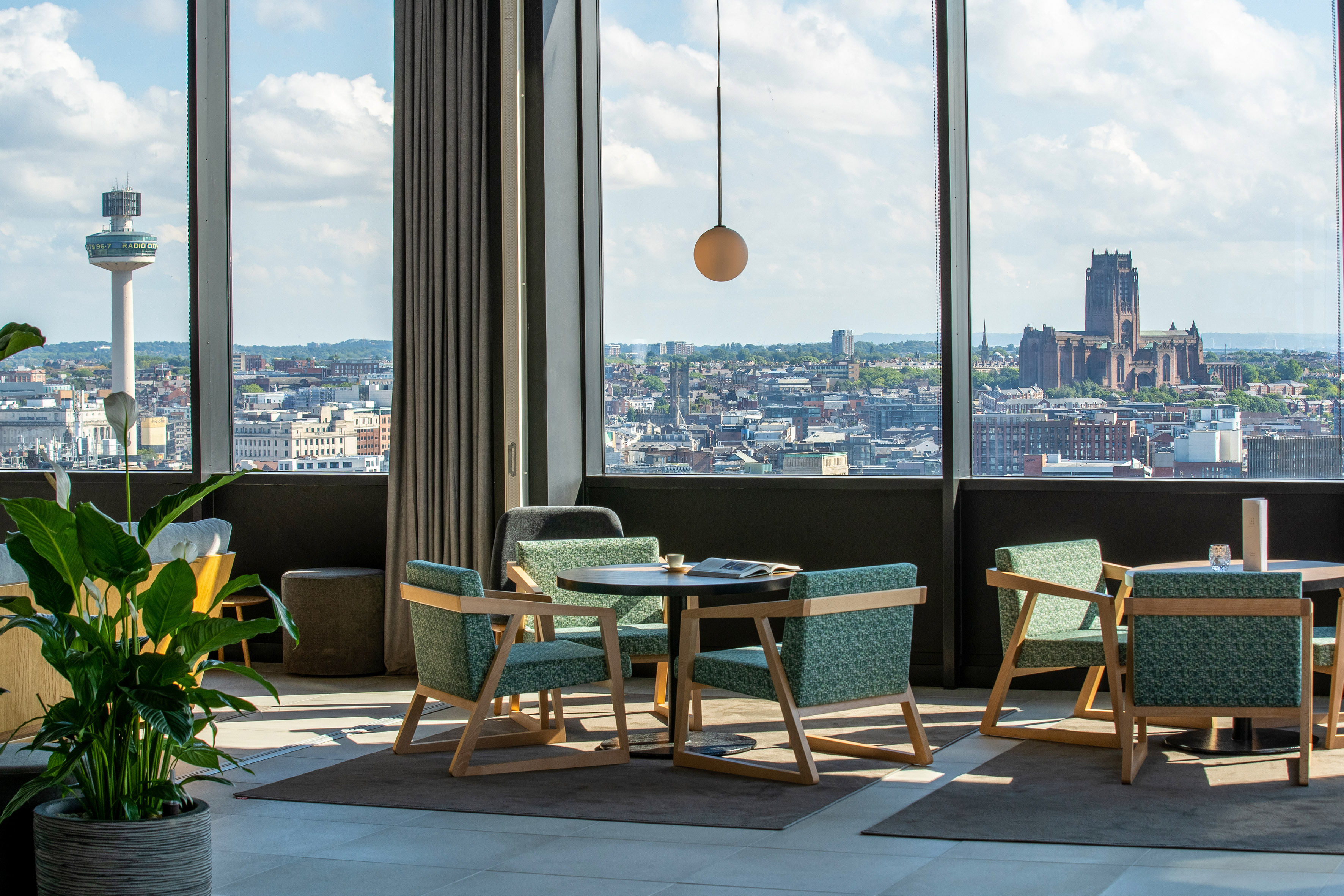 High-rise lounge with Liverpool city view, Radio City Tower & Cathedral.