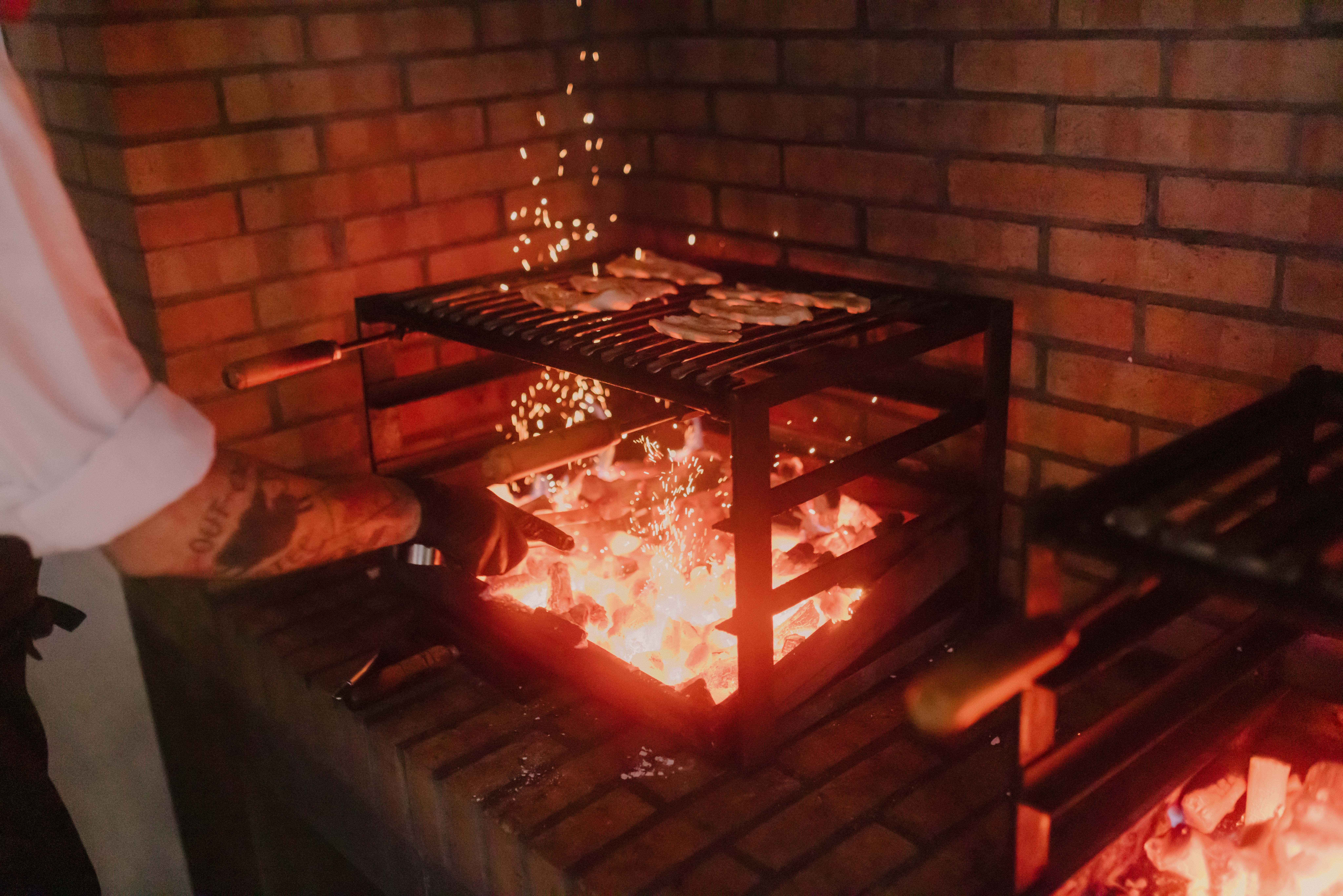 a person cooking food in a grill