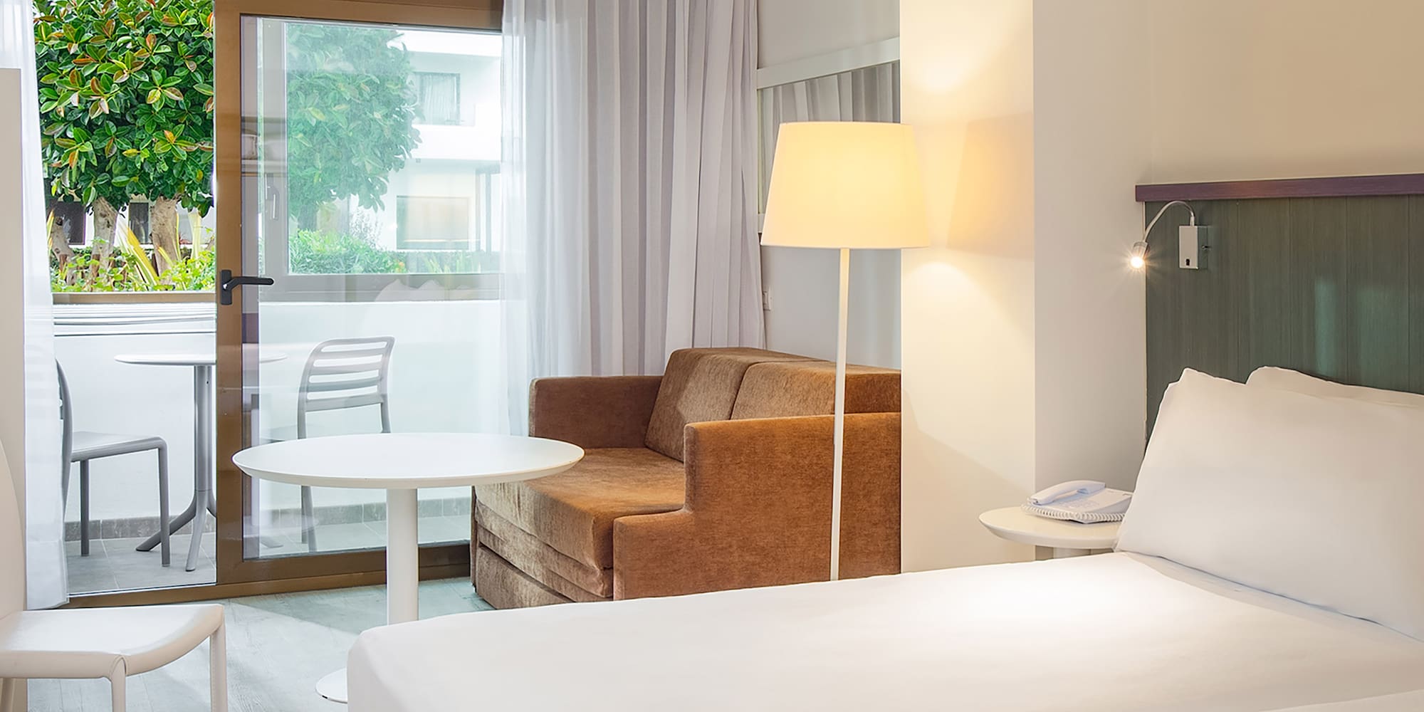 a room with two beds and a chair