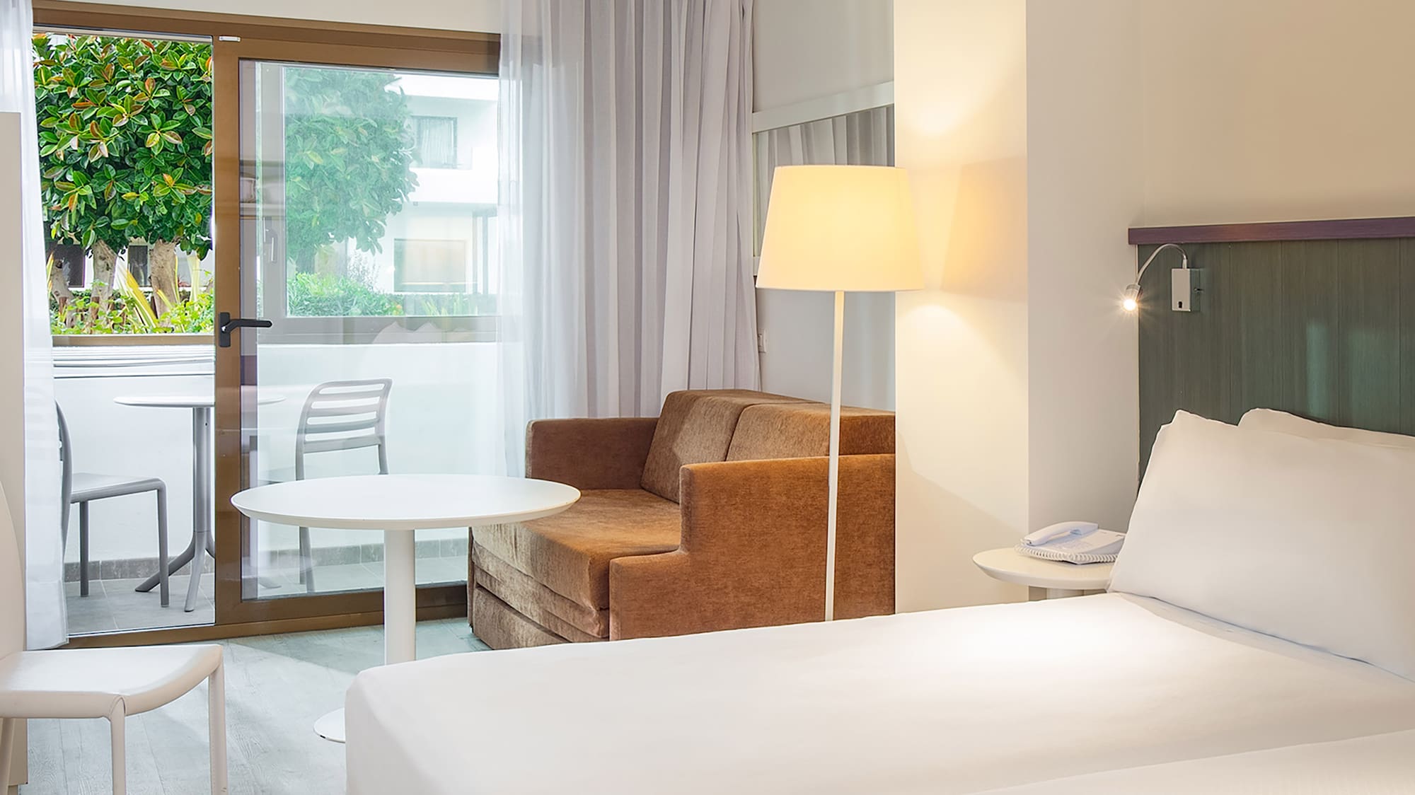 a room with two beds and a chair