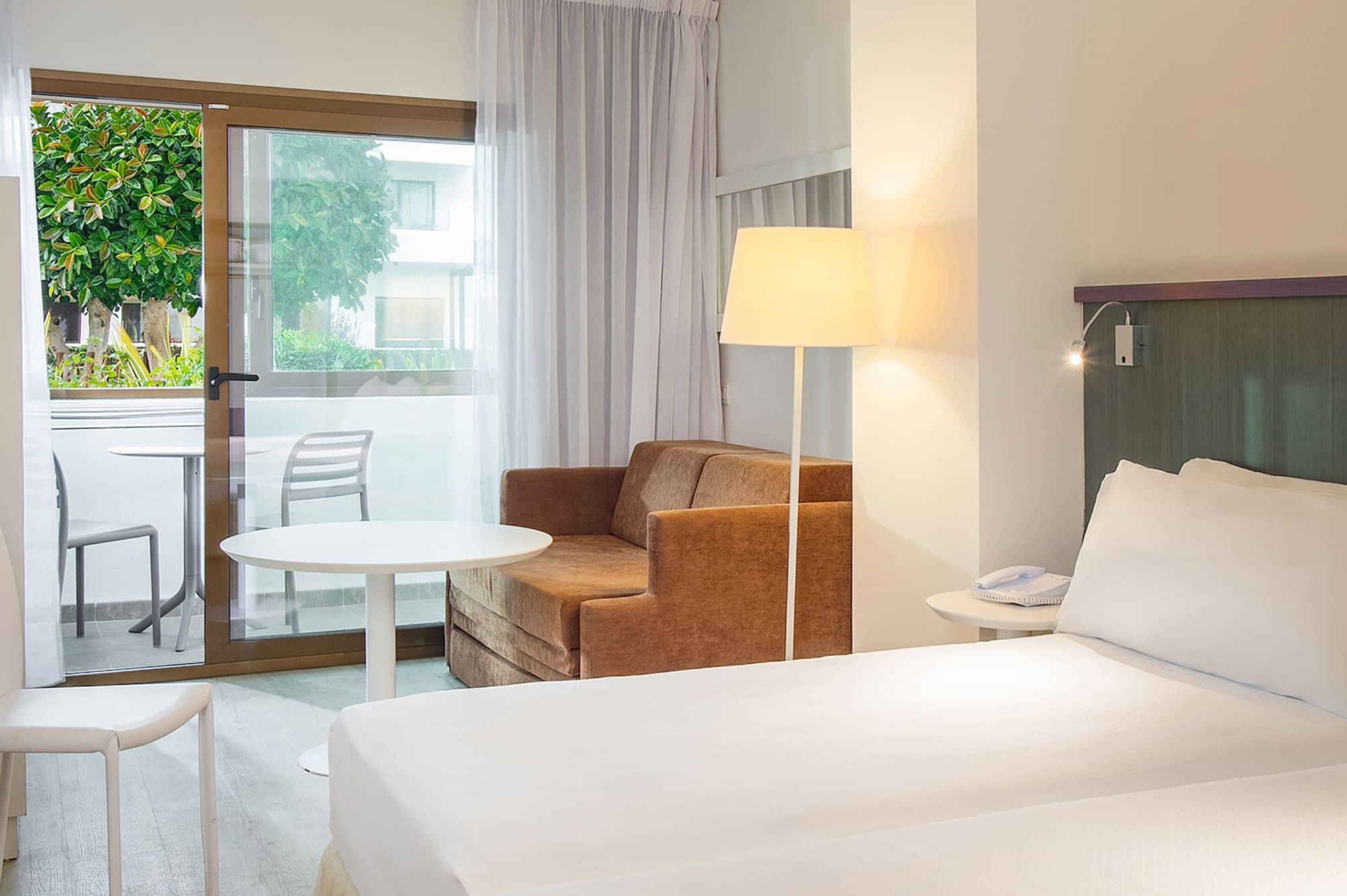 a room with two beds and a chair