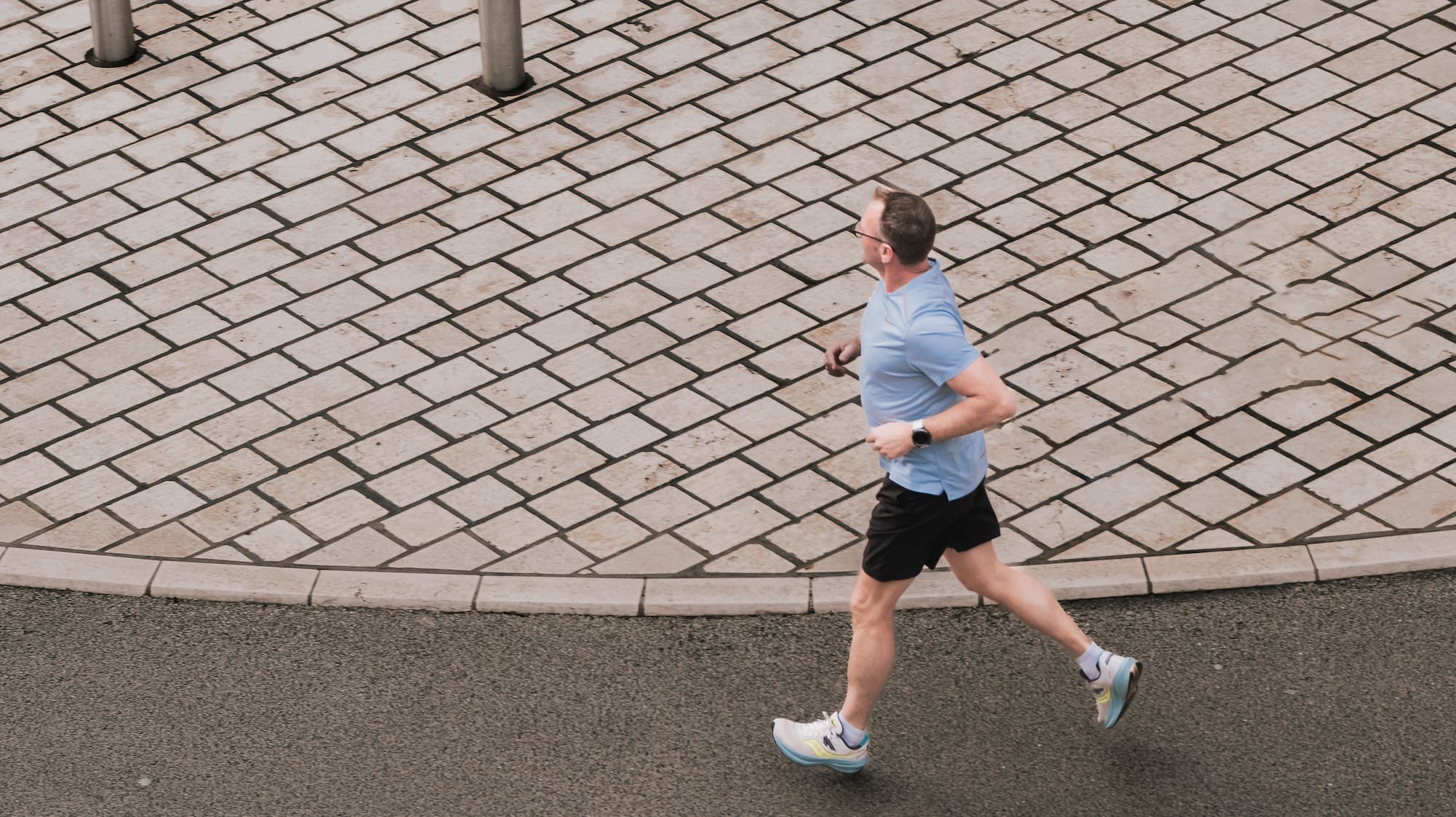 a man running on a brick road