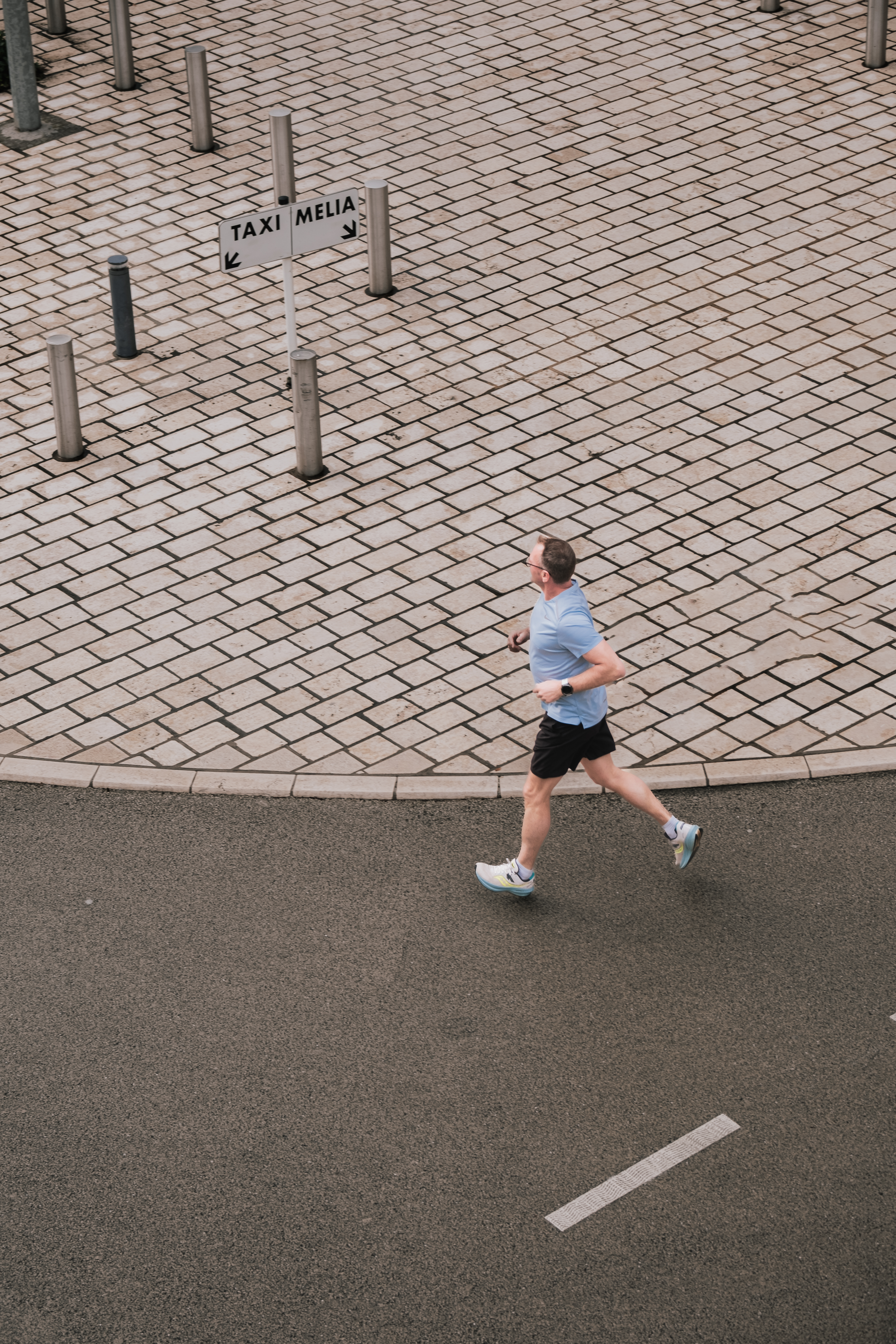 a man running on a brick road