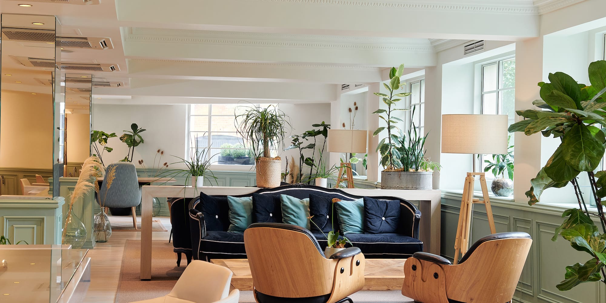 a room with a couch and chairs