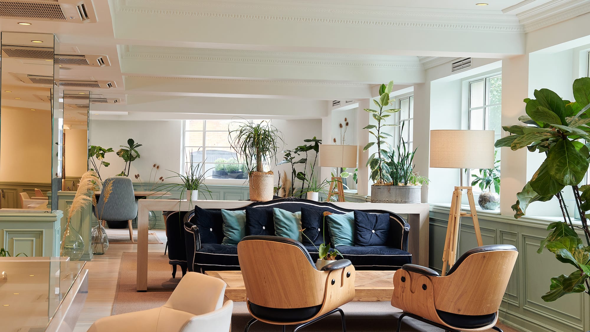 a room with a couch and chairs