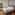 Modern luxury hotel bedroom with large bed, wood floor, and en-suite bathroom.