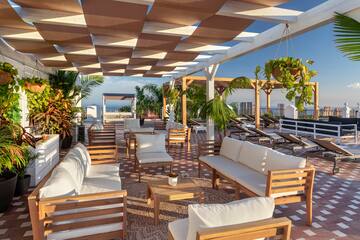 a patio with white furniture and chairs