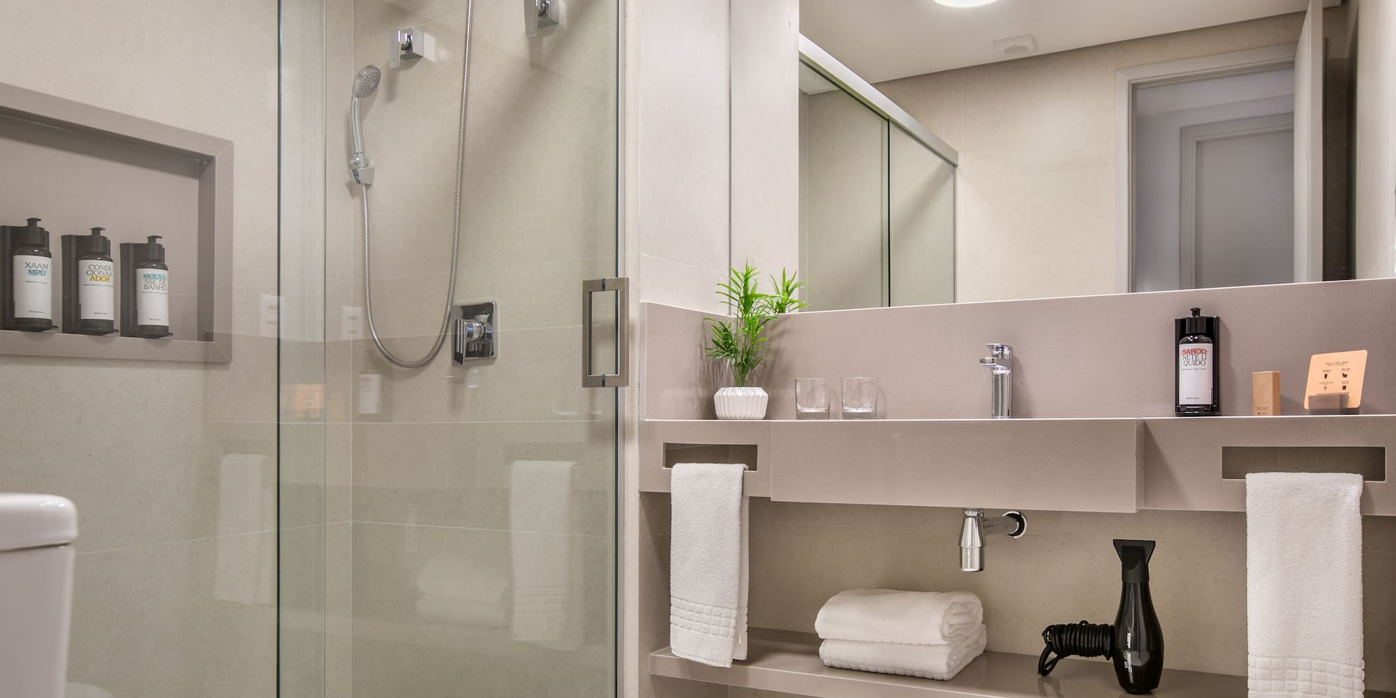 a bathroom with a glass shower and sink