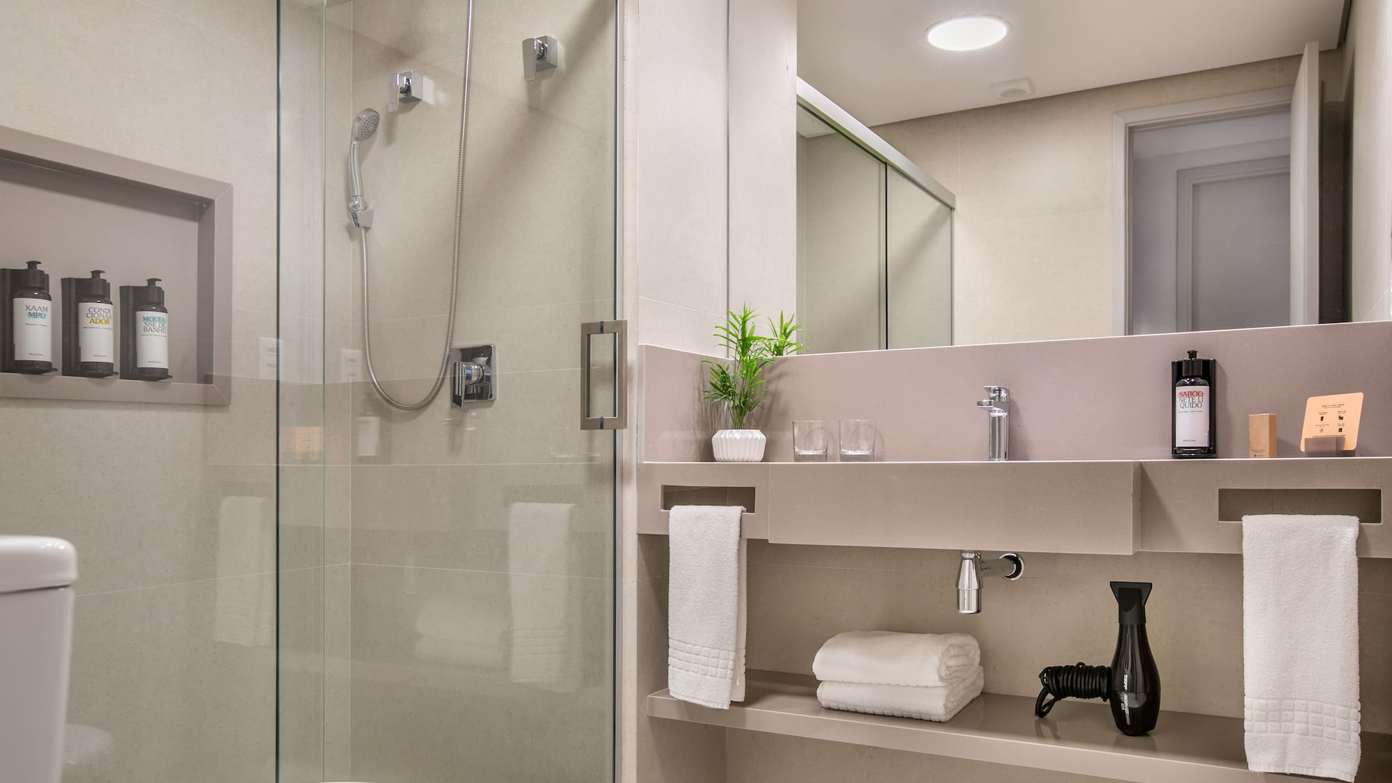 a bathroom with a glass shower and sink