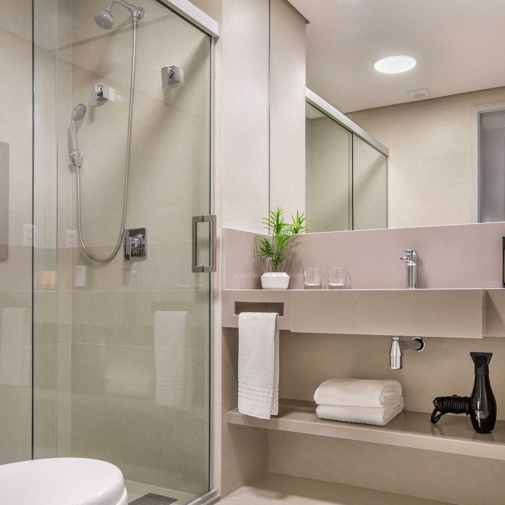 a bathroom with a glass shower and sink