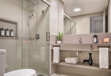 a bathroom with a glass shower and sink