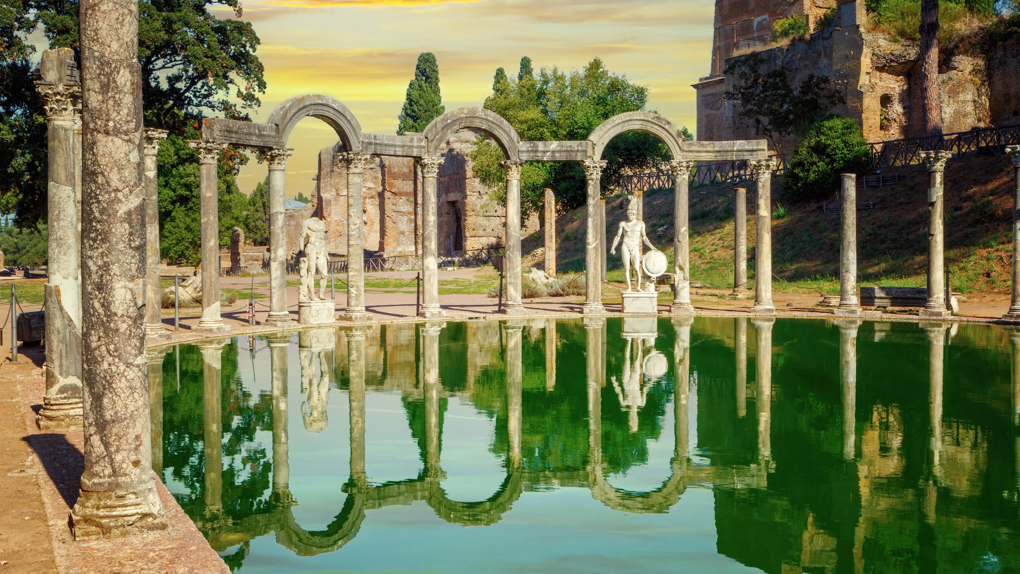 a pool of water with a statue in the middle