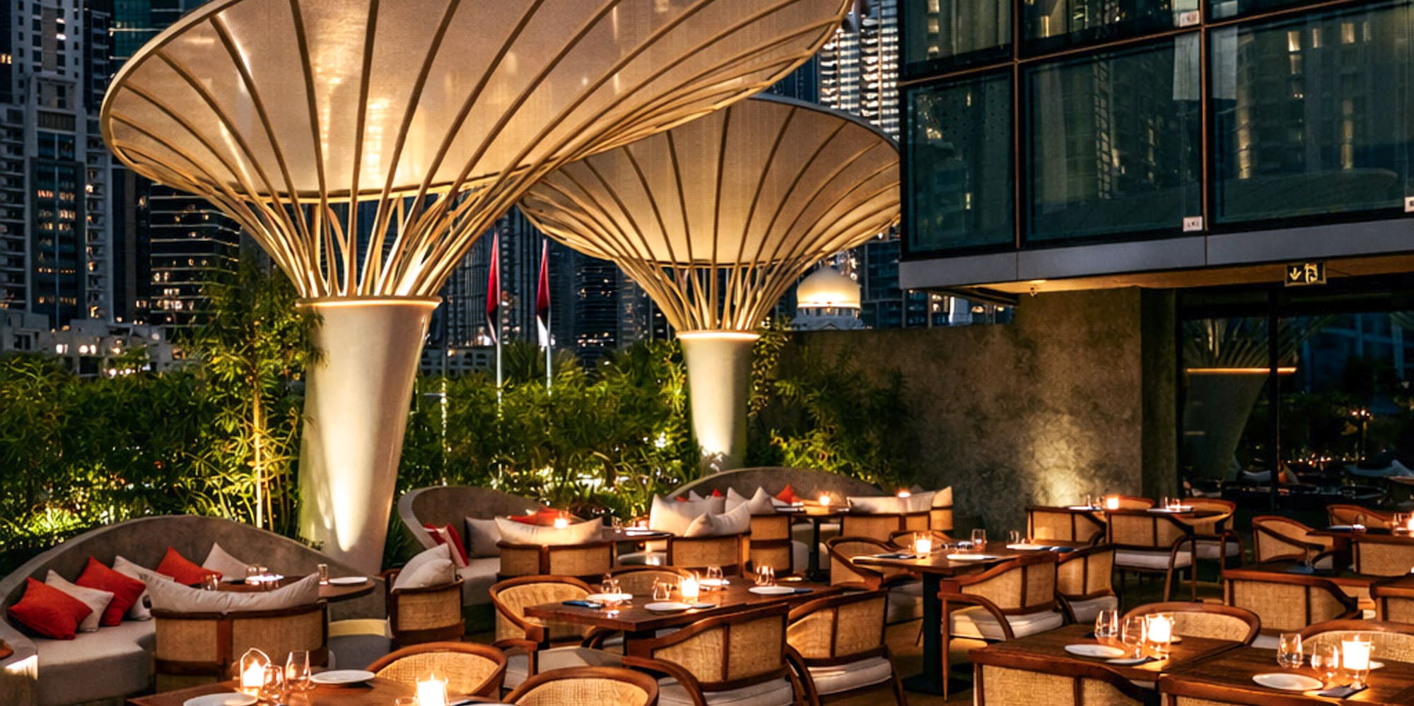 a restaurant with tables and chairs and a city skyline