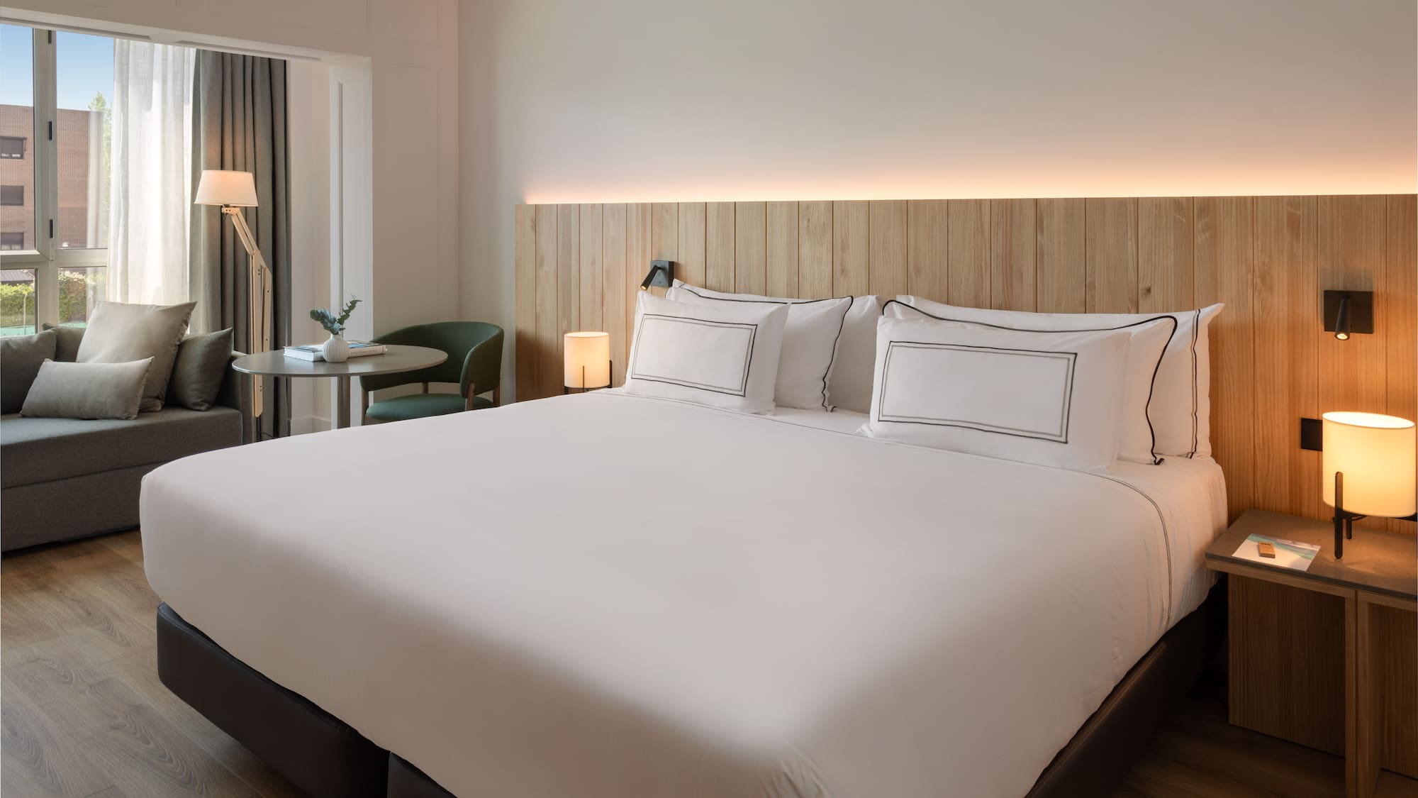 a bed with white sheets and a table in a room