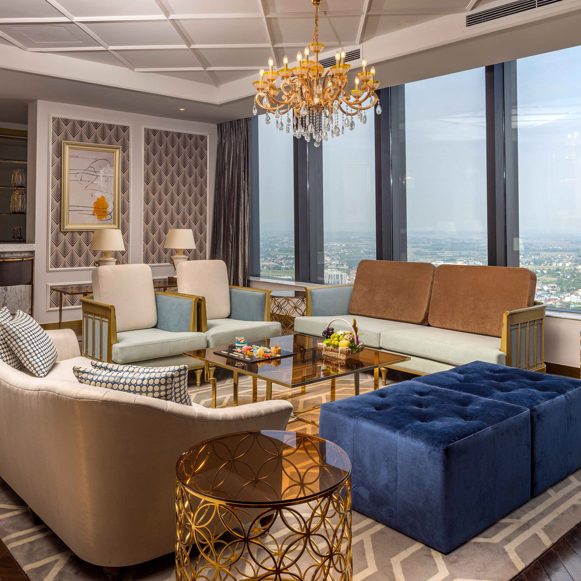 a living room with couches and a chandelier