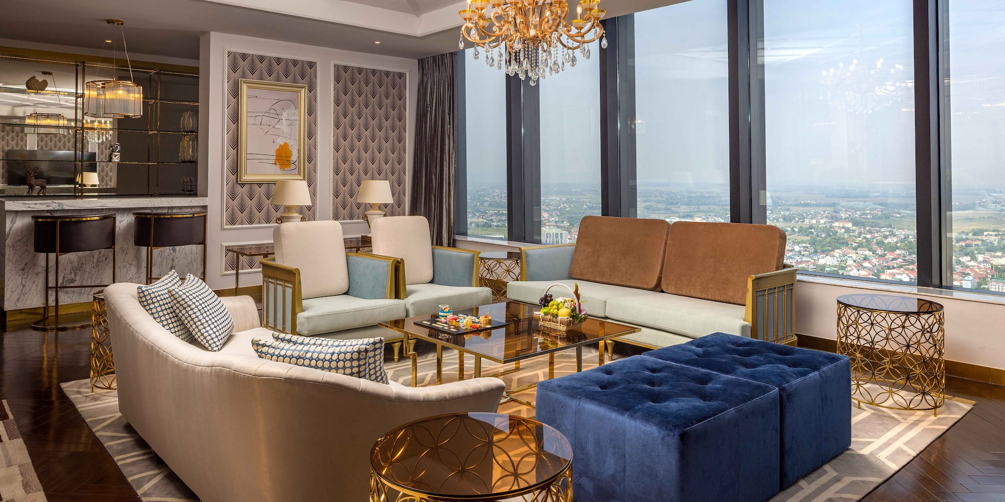a living room with couches and a chandelier