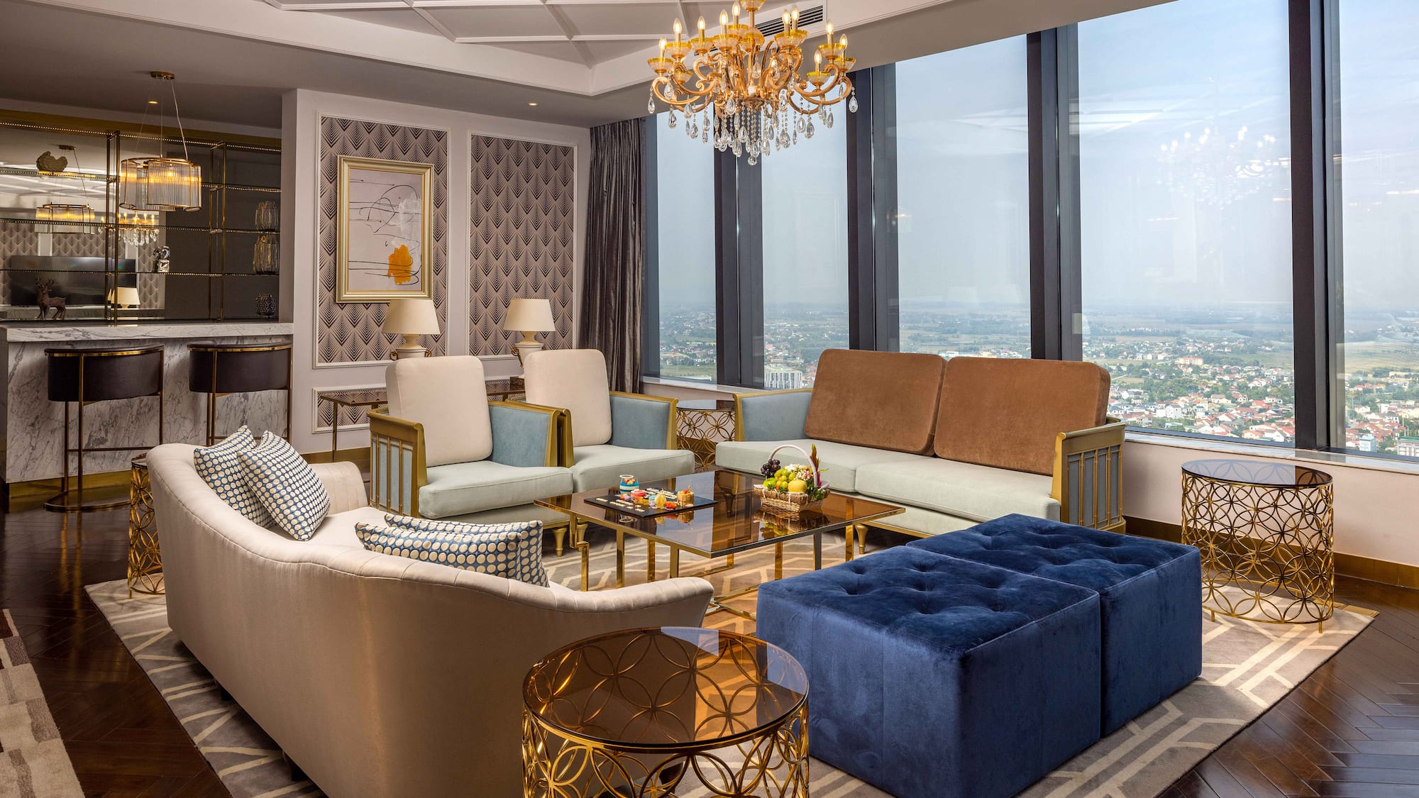 a living room with couches and a chandelier