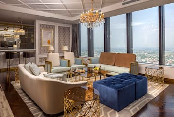 a living room with couches and a chandelier