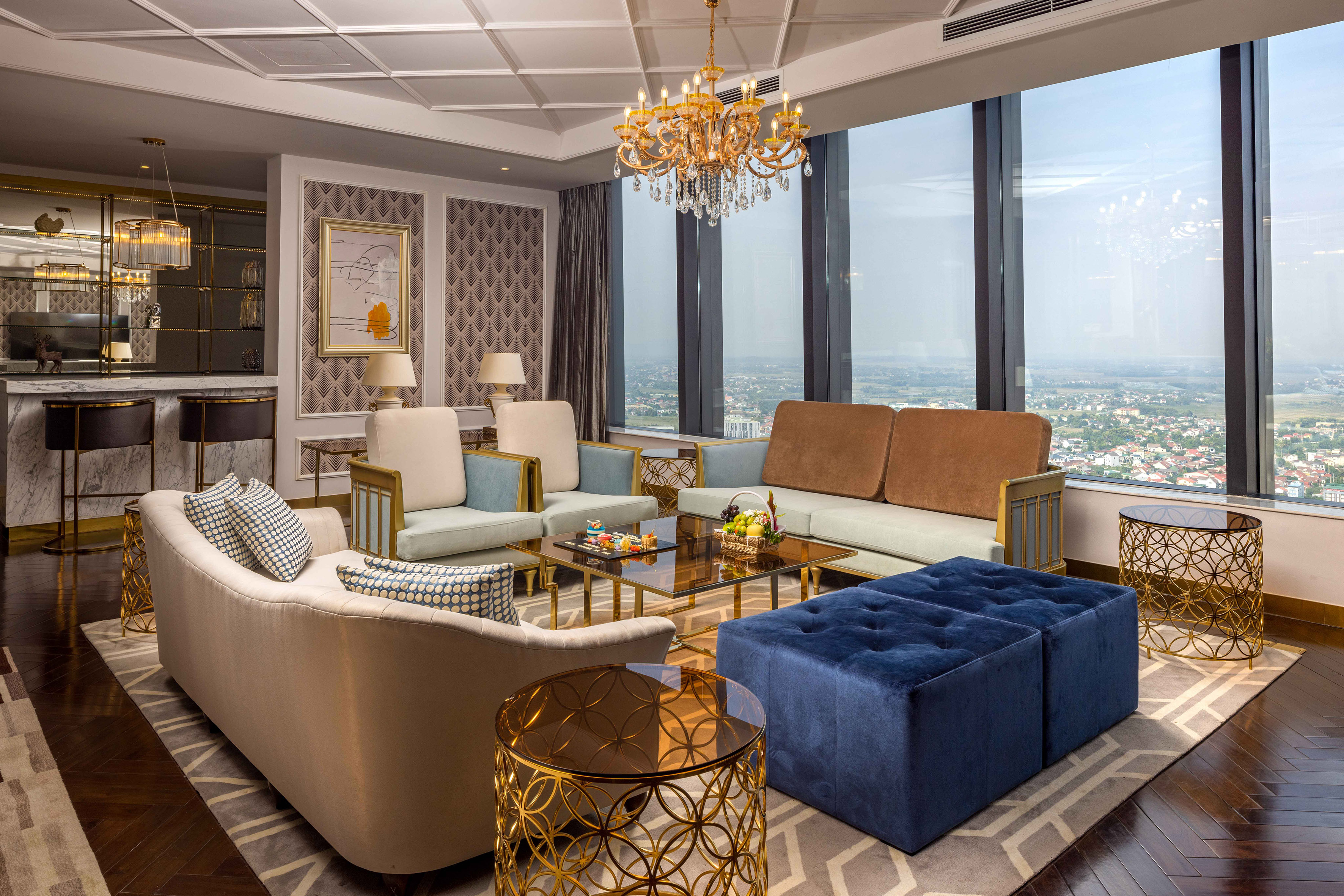 a living room with couches and a chandelier