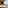 Private balcony with wooden hot tub, daybed, and sea view.