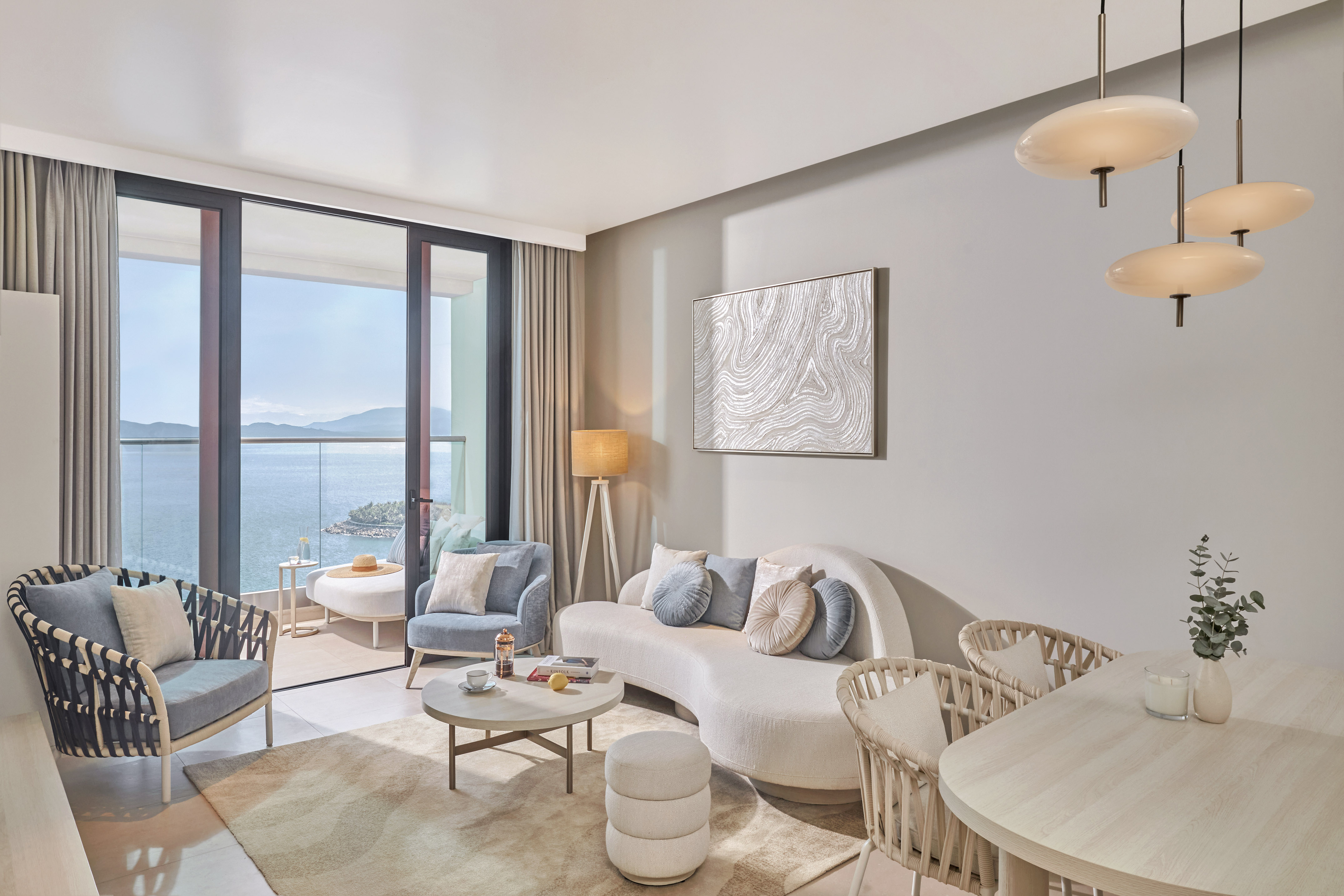 Stylish ocean view living room with balcony and modern furniture.