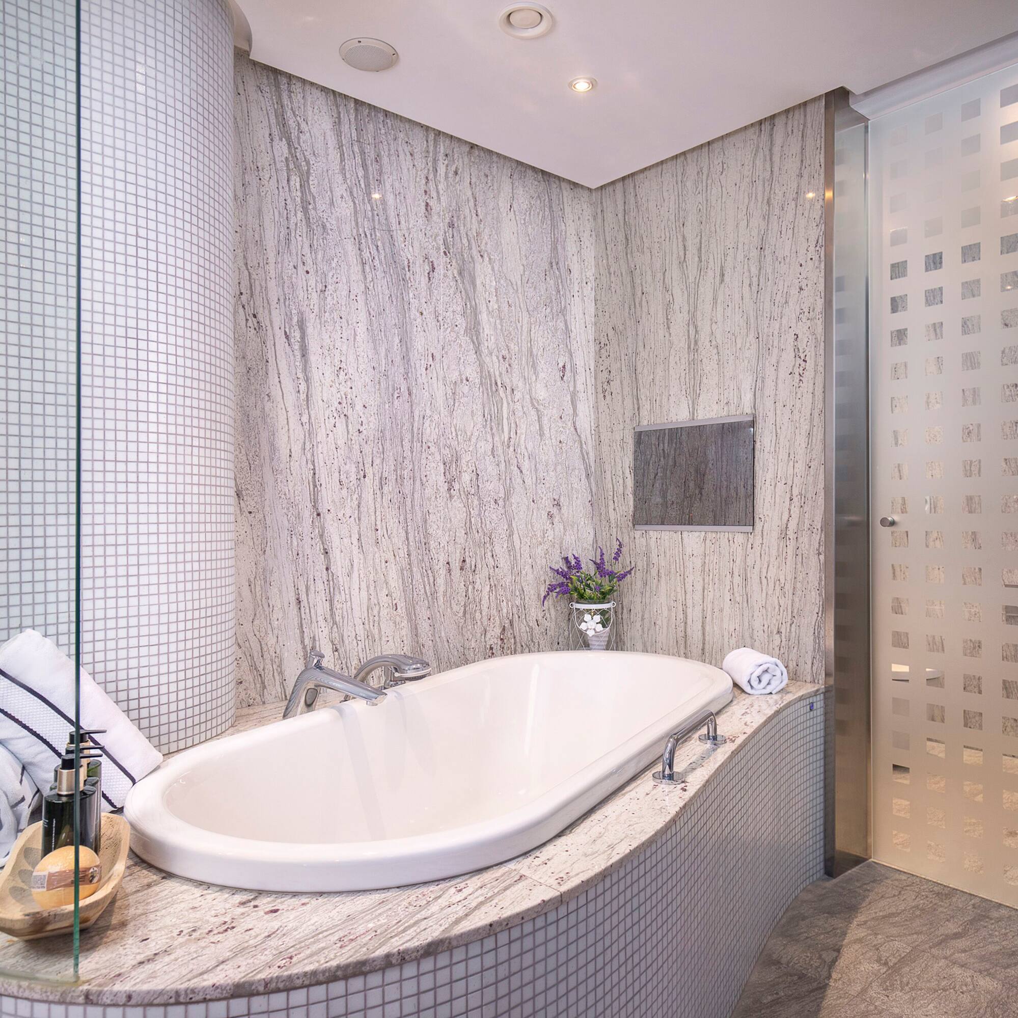 a bathroom with a tub and shower