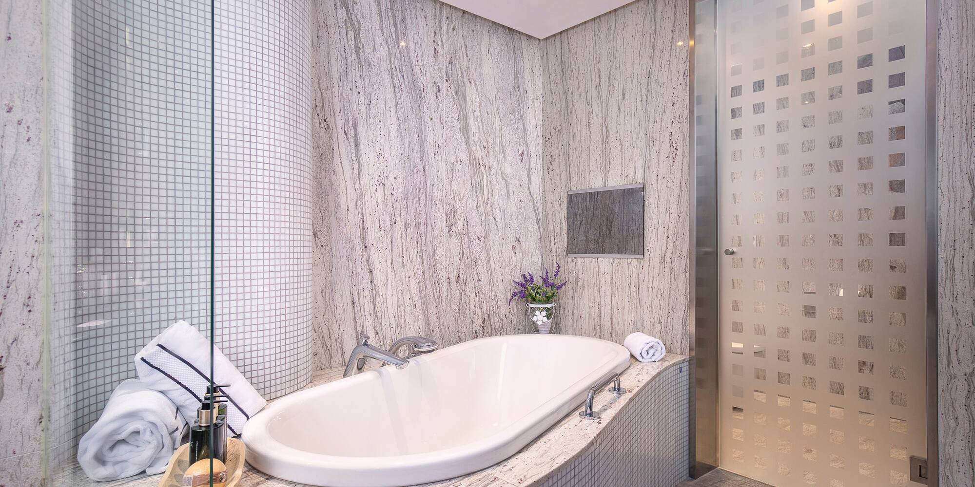 a bathroom with a tub and shower