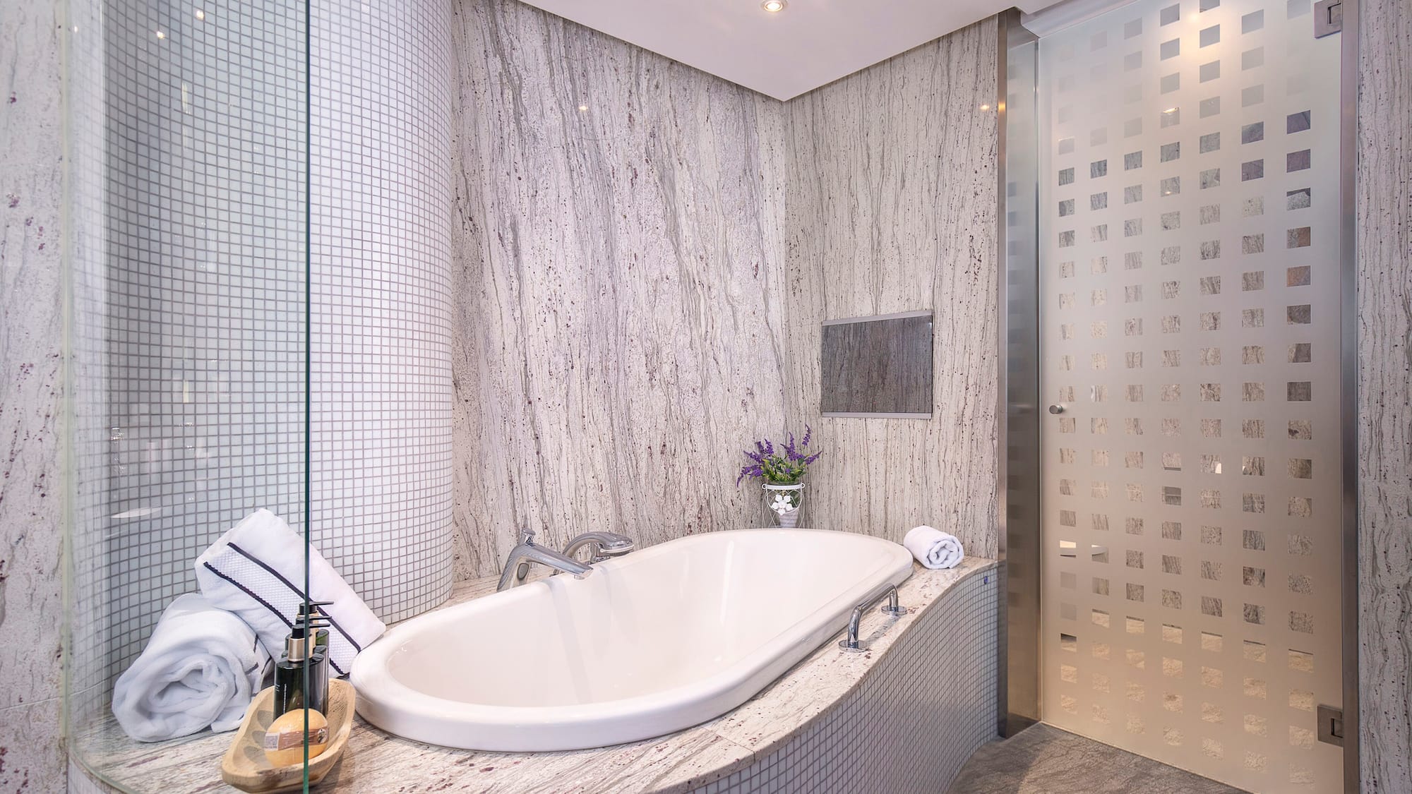 a bathroom with a tub and shower